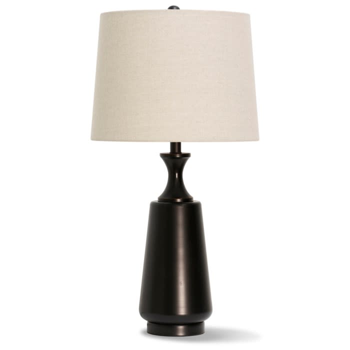Modern table lamp with a dark base and light fabric shade.