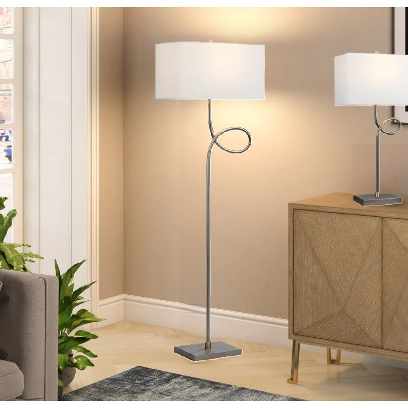 Modern floor lamp with a square shade and curved metal stem in a living room.