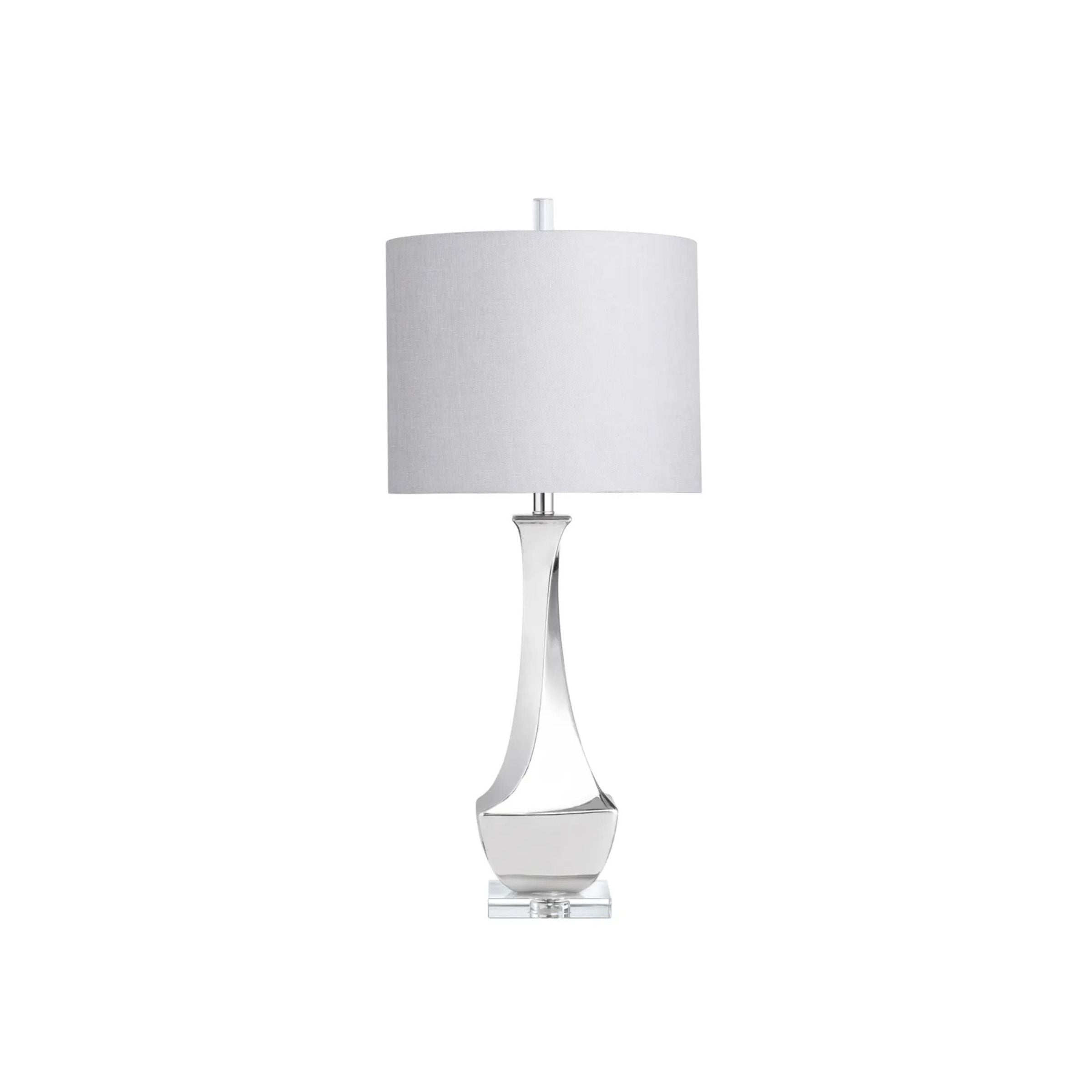 Modern table lamp with a silver base and white fabric shade.