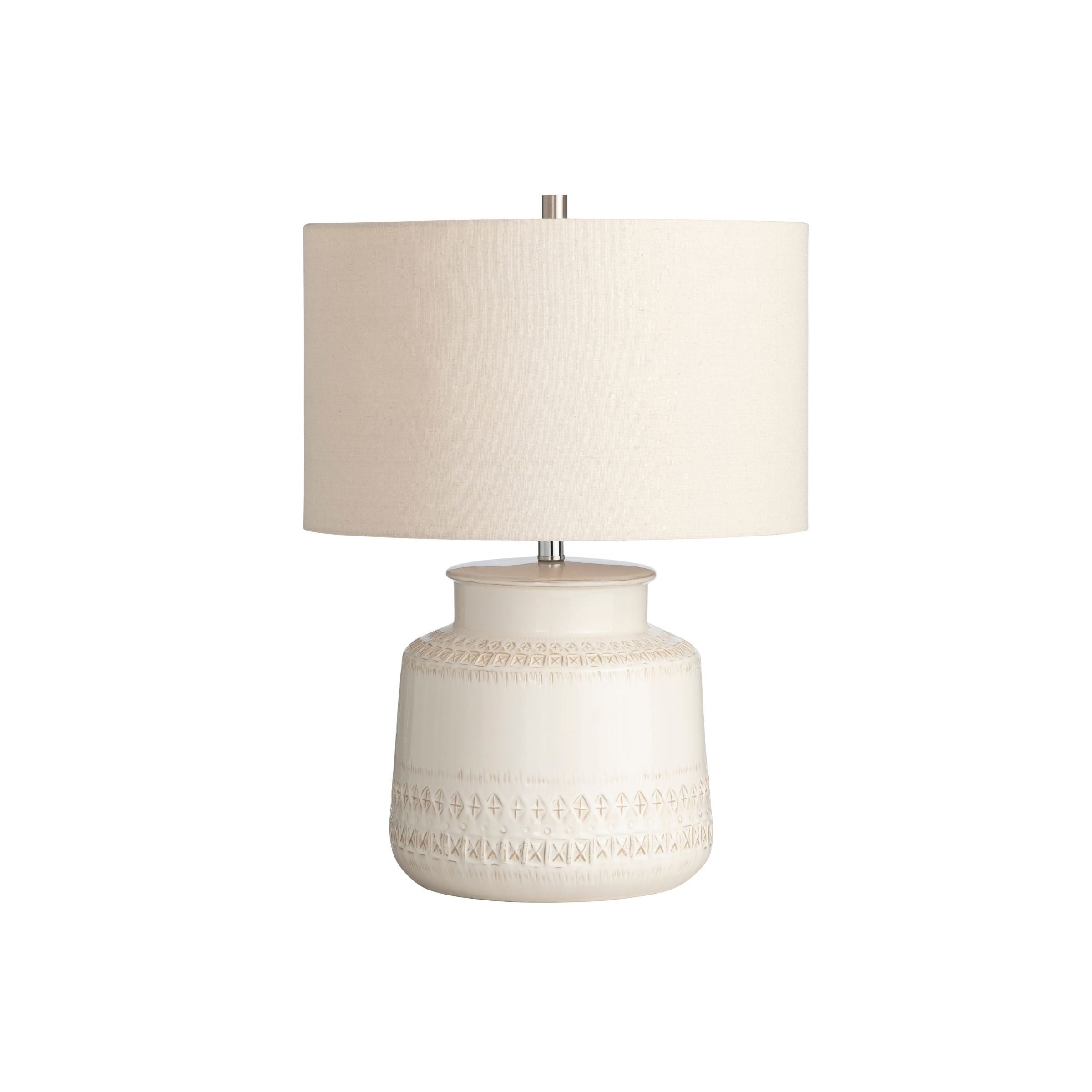 Beige ceramic table lamp with an off-white drum shade.