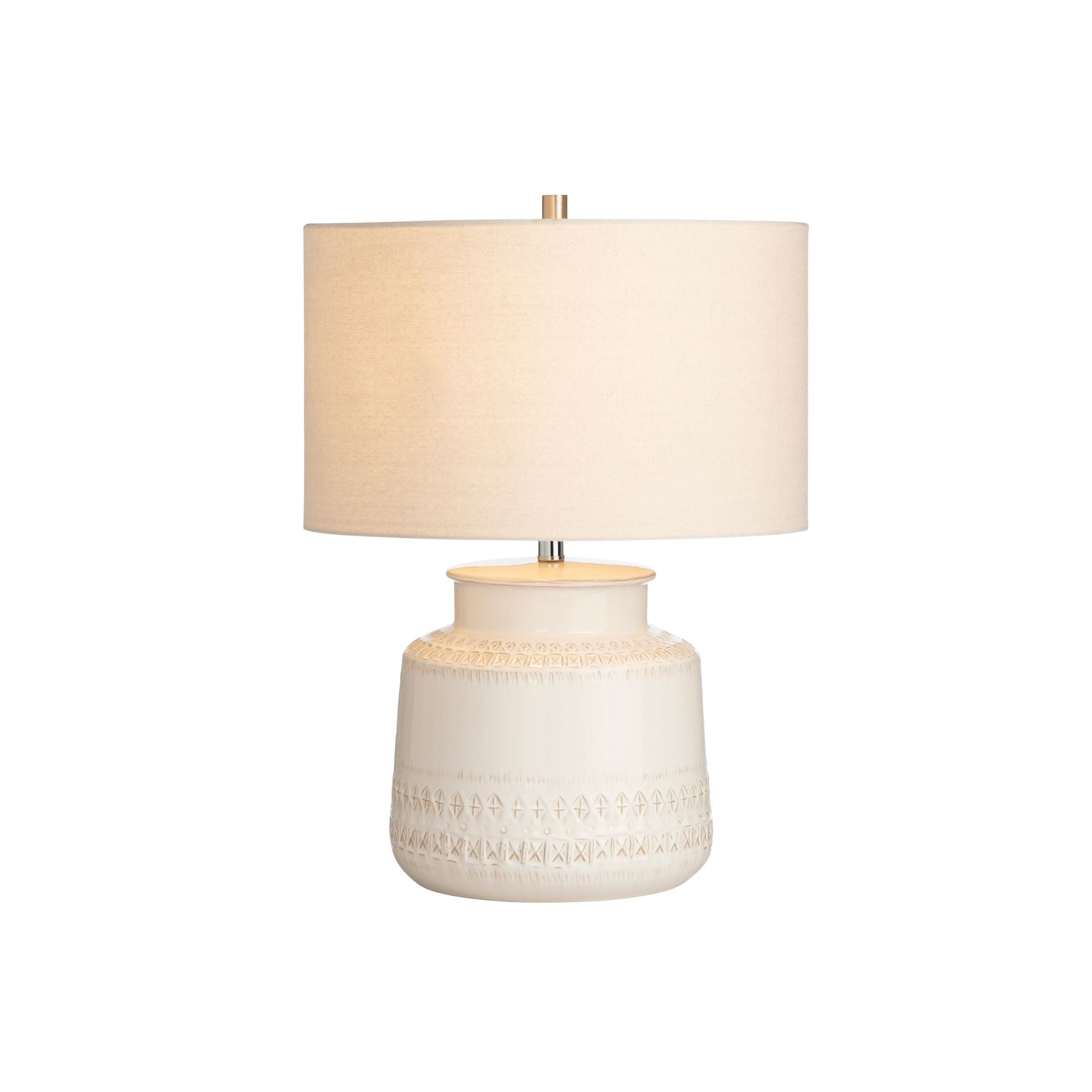 Beige ceramic table lamp with a textured base and a fabric lampshade.
