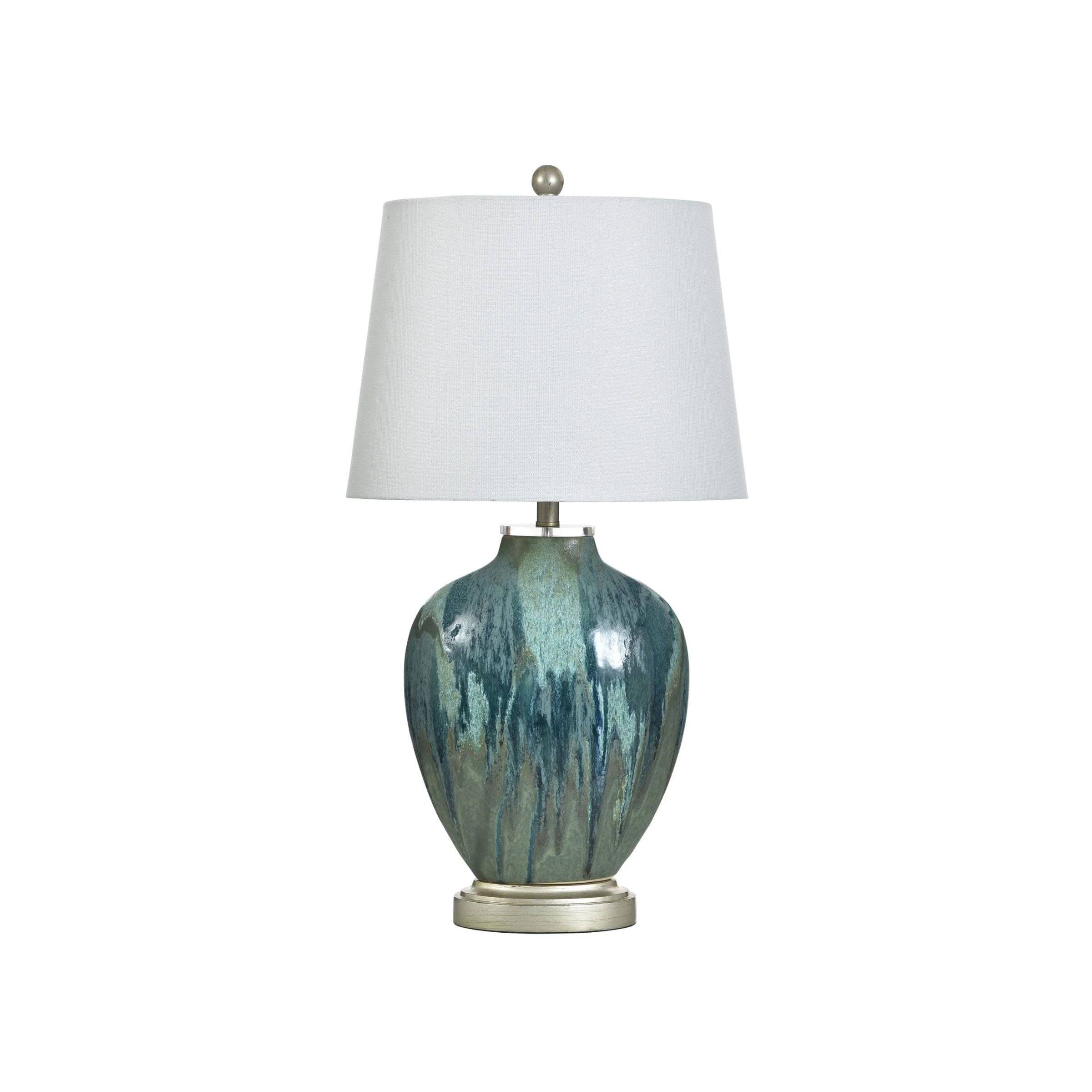 Table lamp with a blue-green ceramic base and white lampshade.