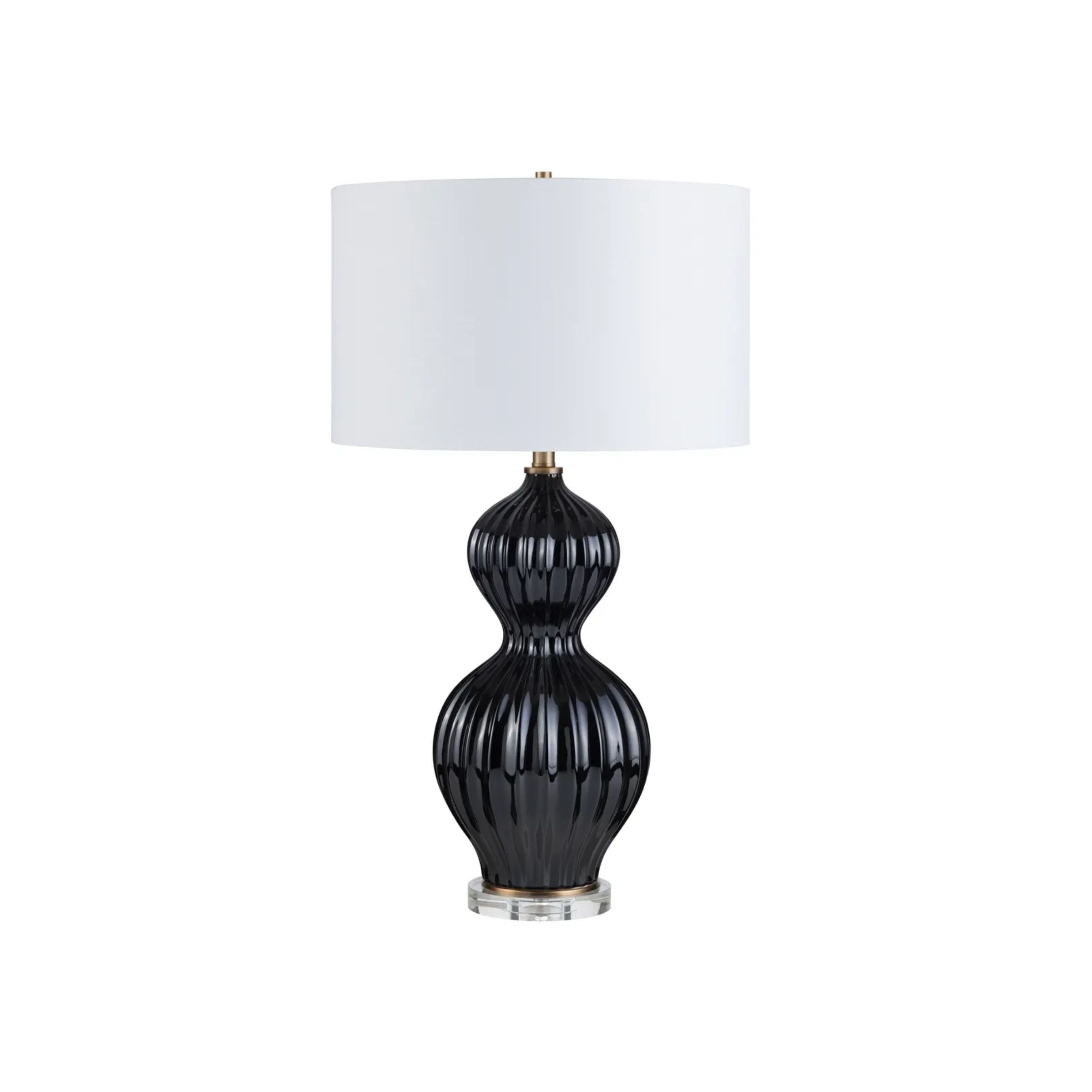 Black ceramic table lamp with a white drum shade.