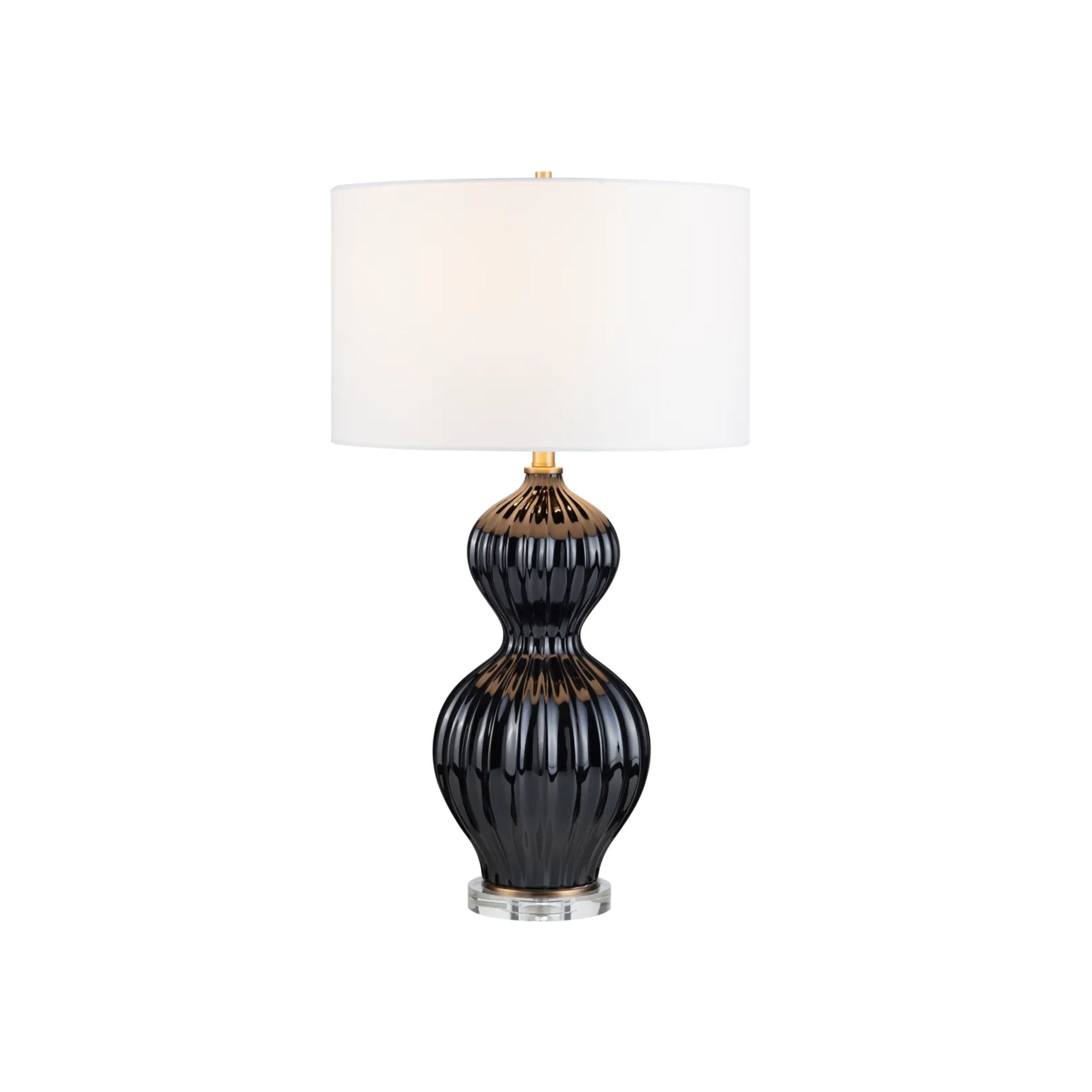 Black ceramic table lamp with white drum shade.