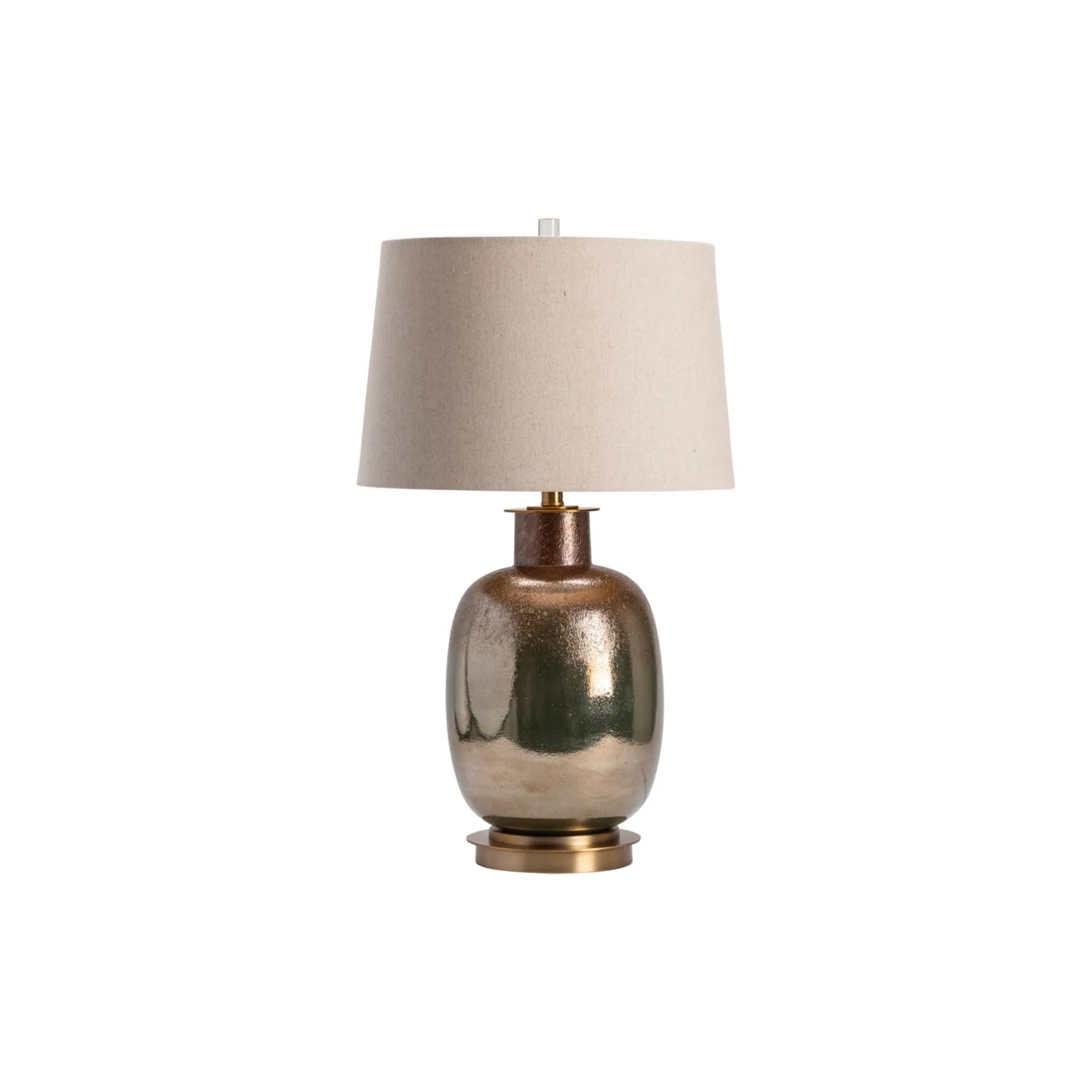 Bronze ceramic table lamp with beige fabric shade on white background.