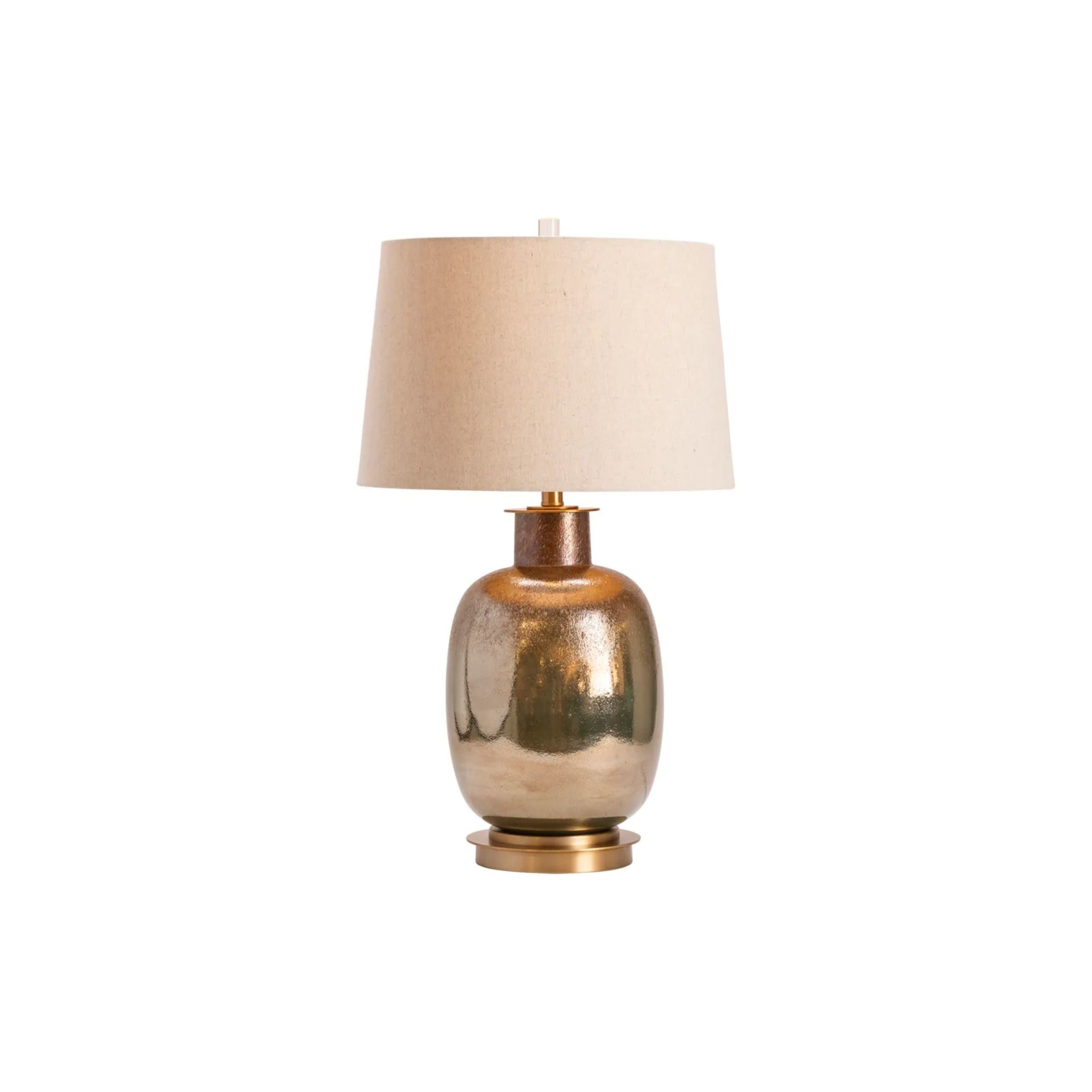 Gold ceramic table lamp with a beige fabric shade on a white background.