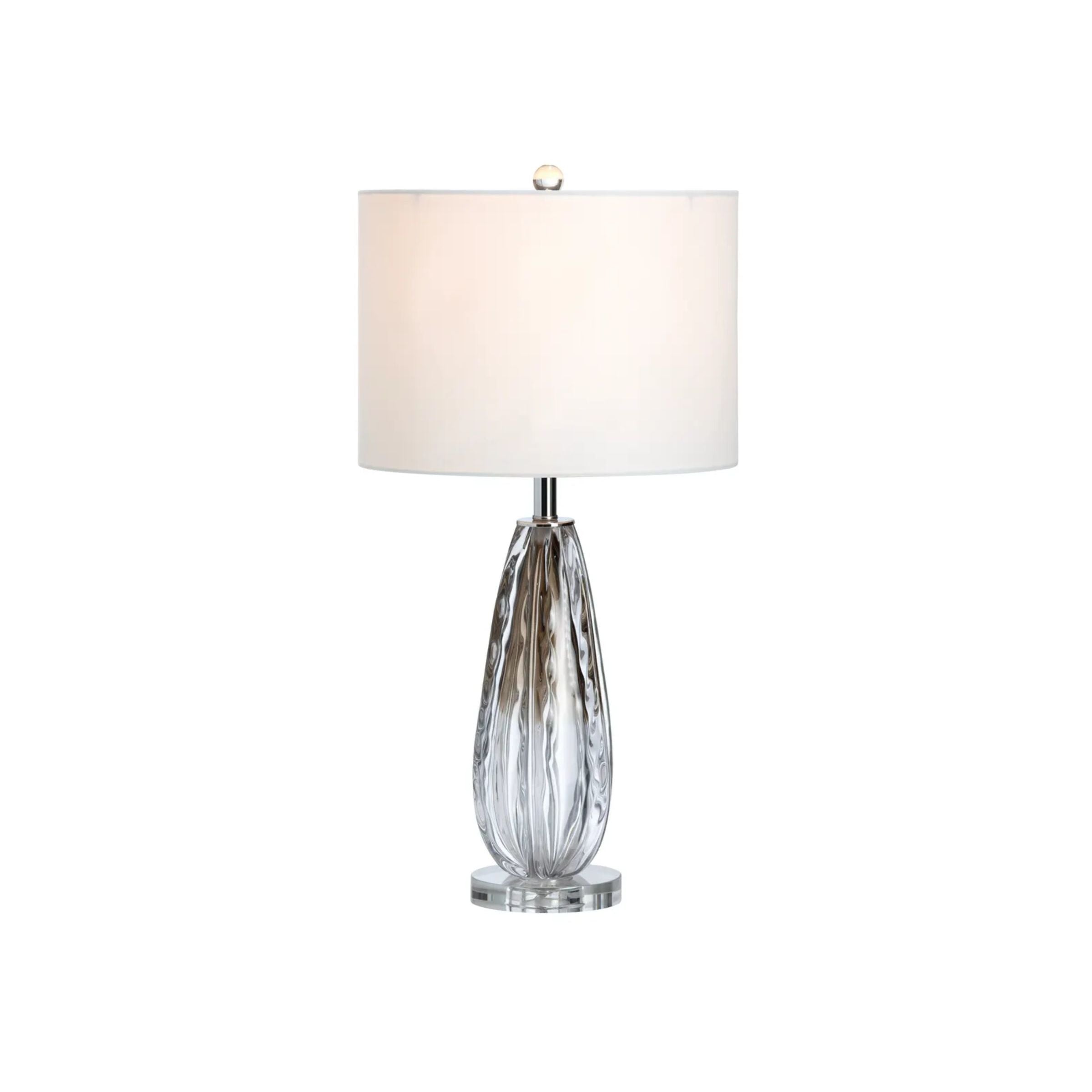 Modern table lamp with a clear textured glass base and white lampshade.