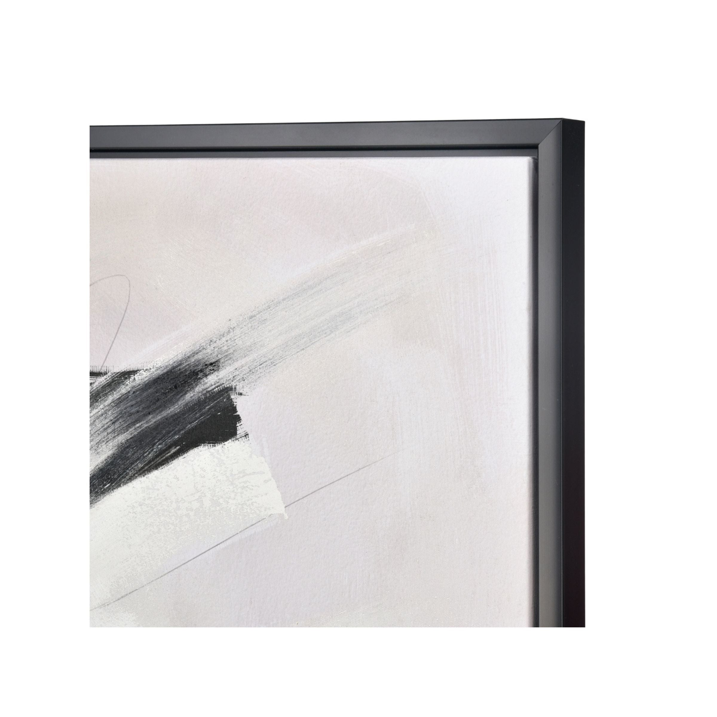 Close-up of framed abstract painting with black and white brushstrokes.
