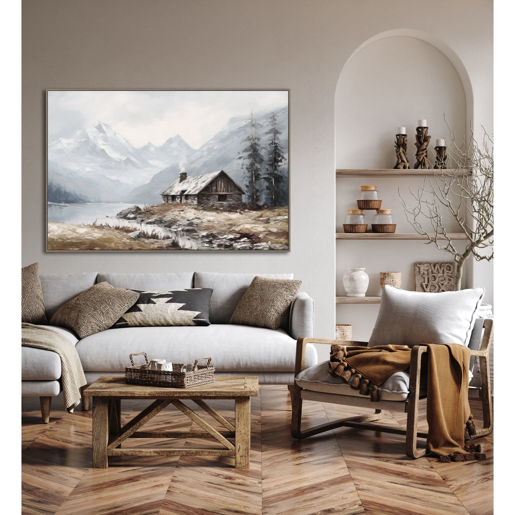 Neutral living room with a gray sofa, wooden table, and mountain cabin artwork on the wall.