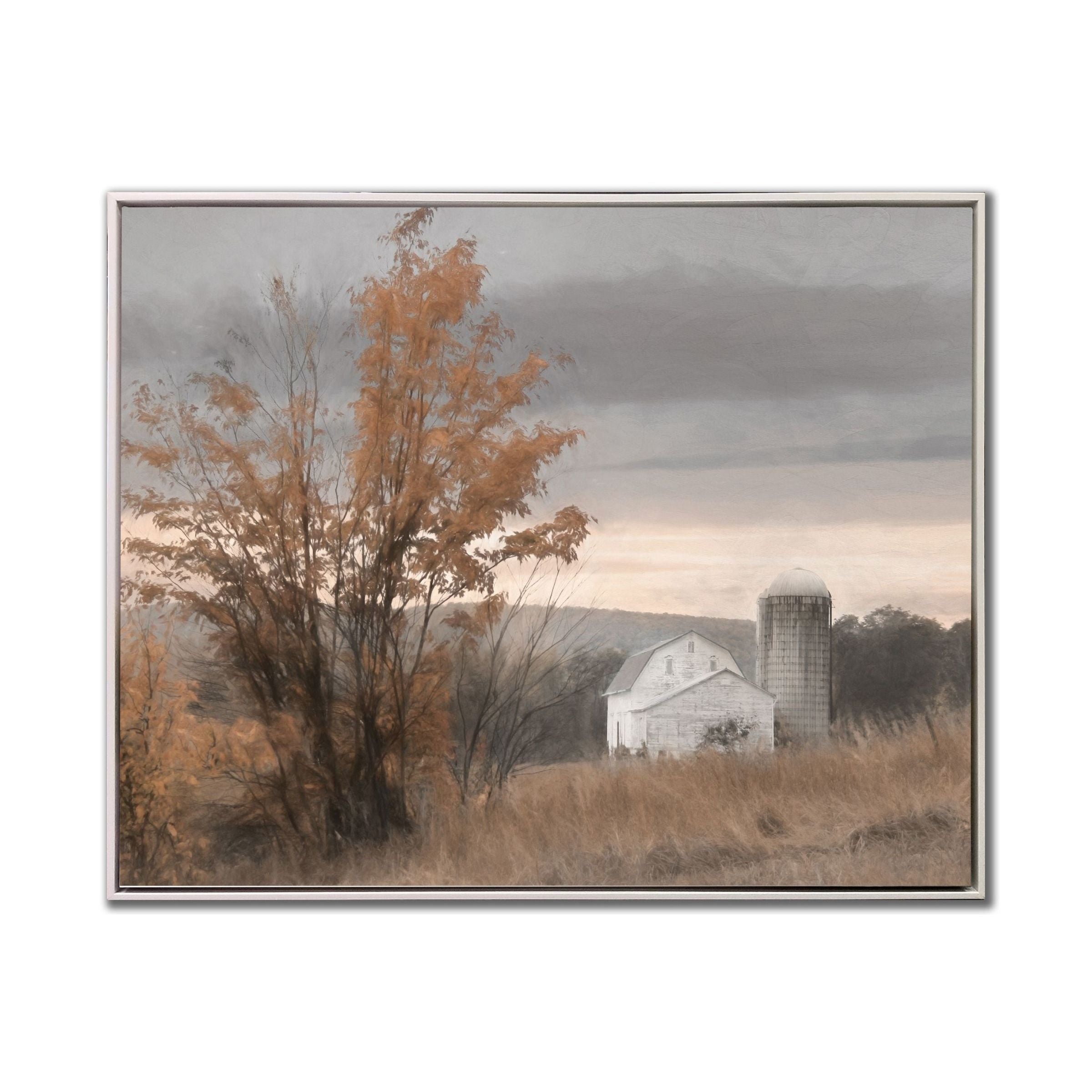 Framed art of a rural barn and silo beside autumn trees under a cloudy sky.