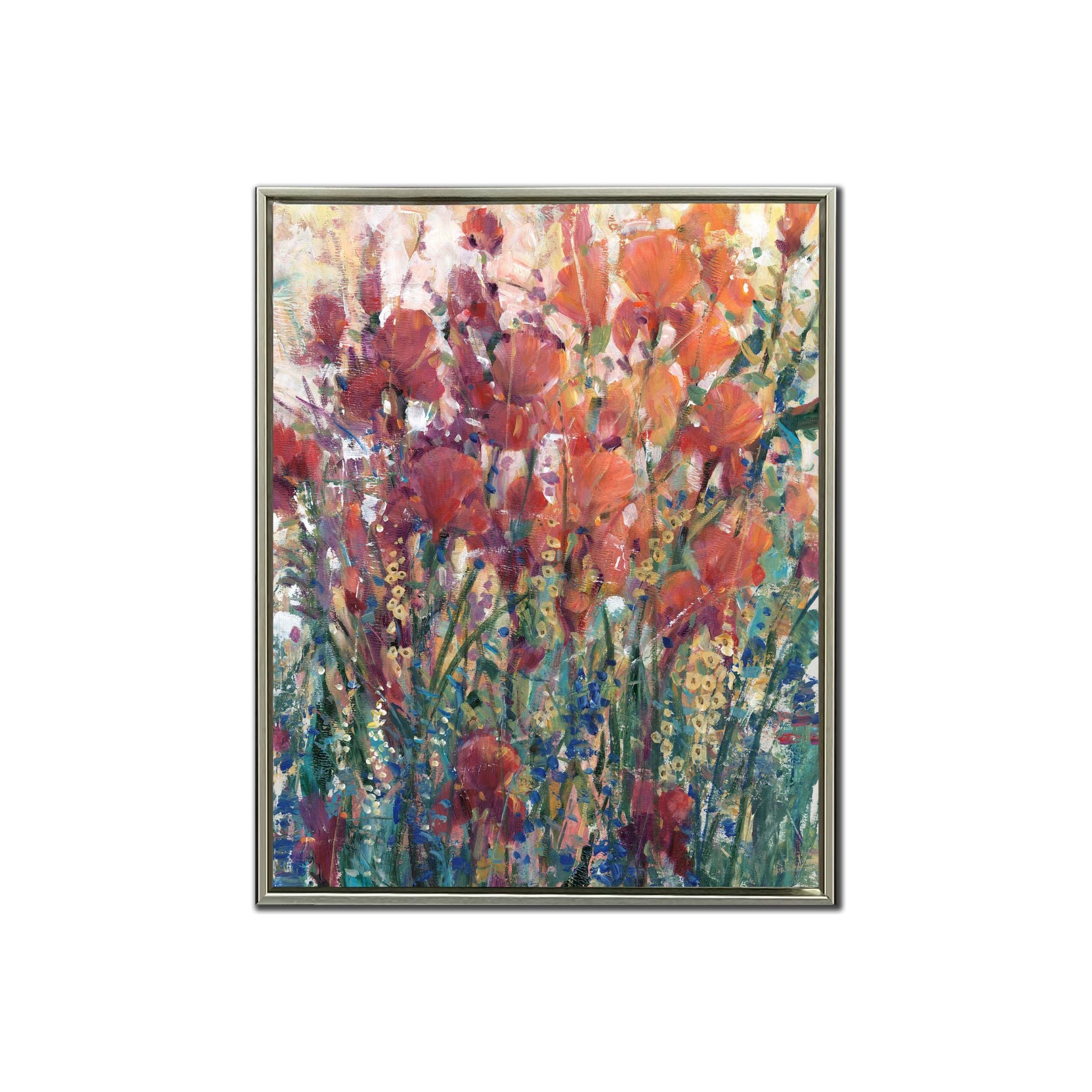 Abstract painting of vibrant red flowers in a silver frame.