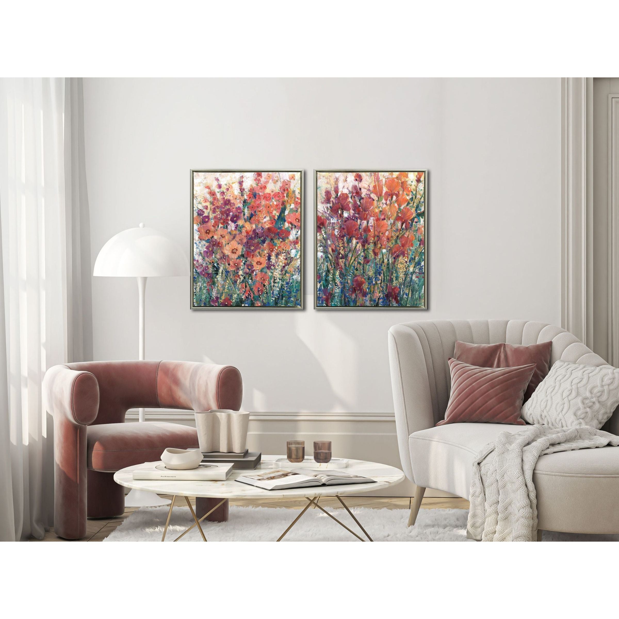 Modern living room with two colorful floral paintings above a sofa and armchair.