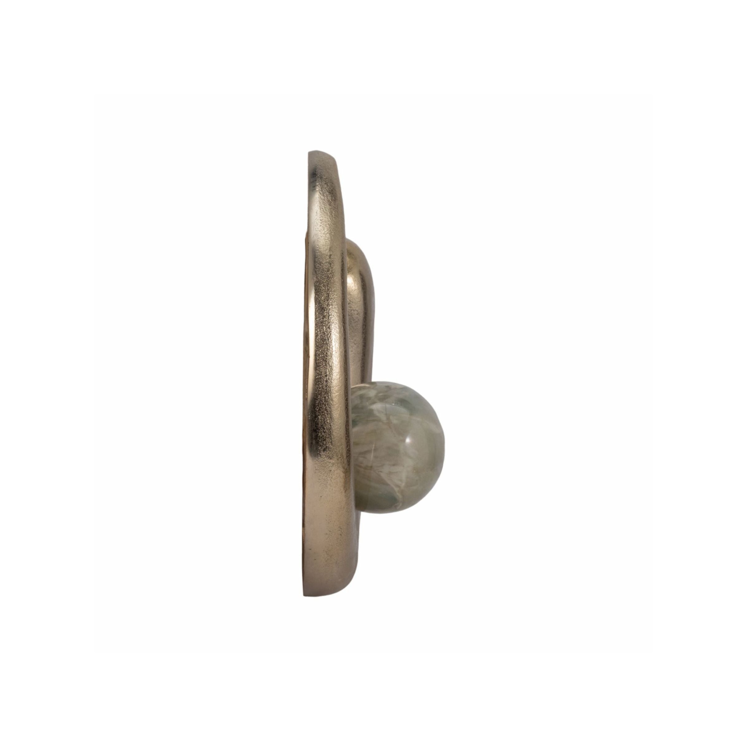 Side view of a round gold metal wall hook with a green marbled stone accent.