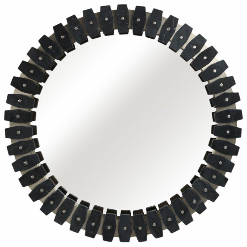 Round mirror with dark geometric frame and metallic accents.
