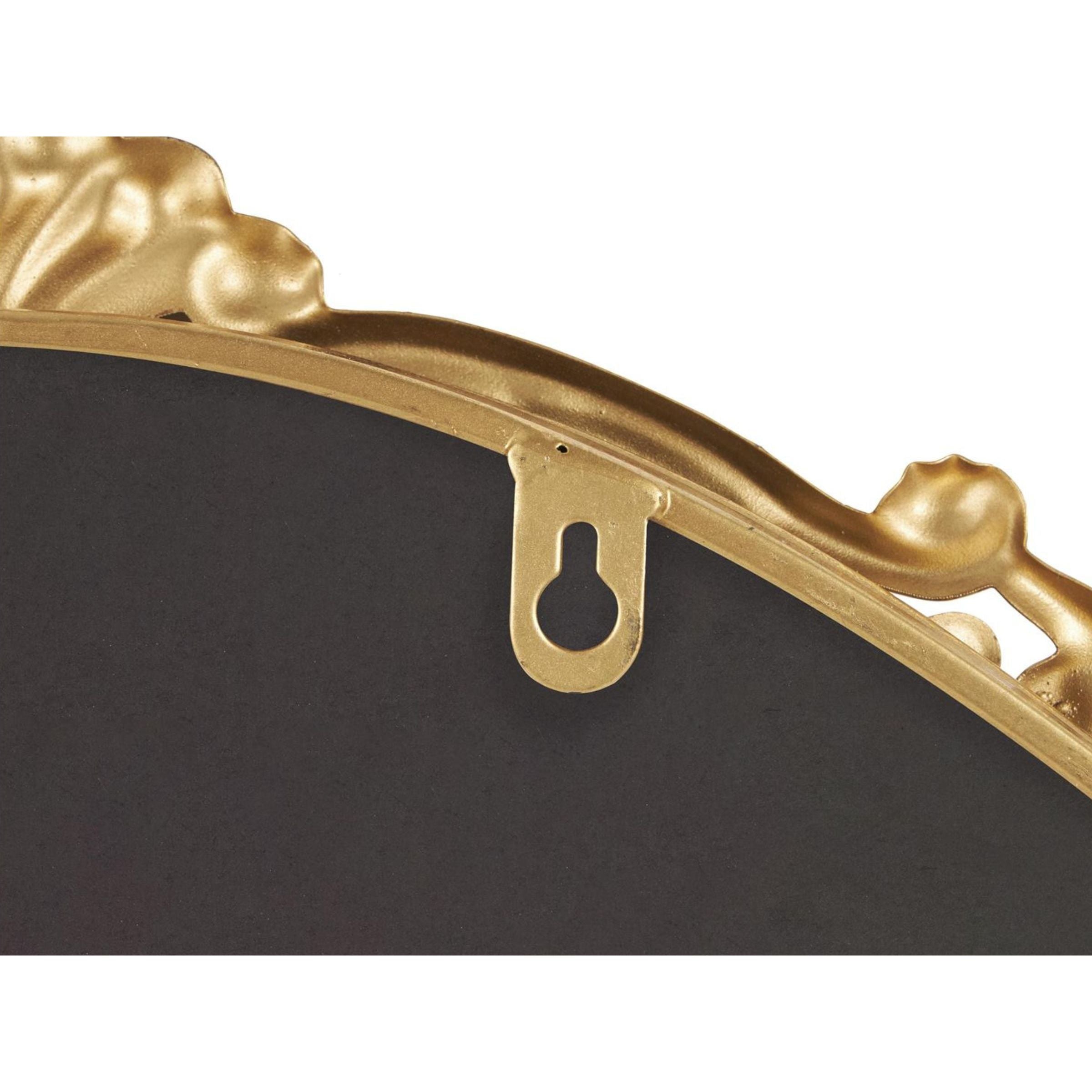 Close-up of a gold frame edge with a keyhole hanger for wall mounting.