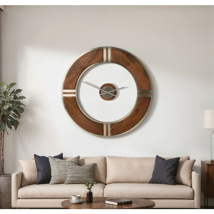 Large round wood and metal wall clock above a beige sofa in a modern living room.