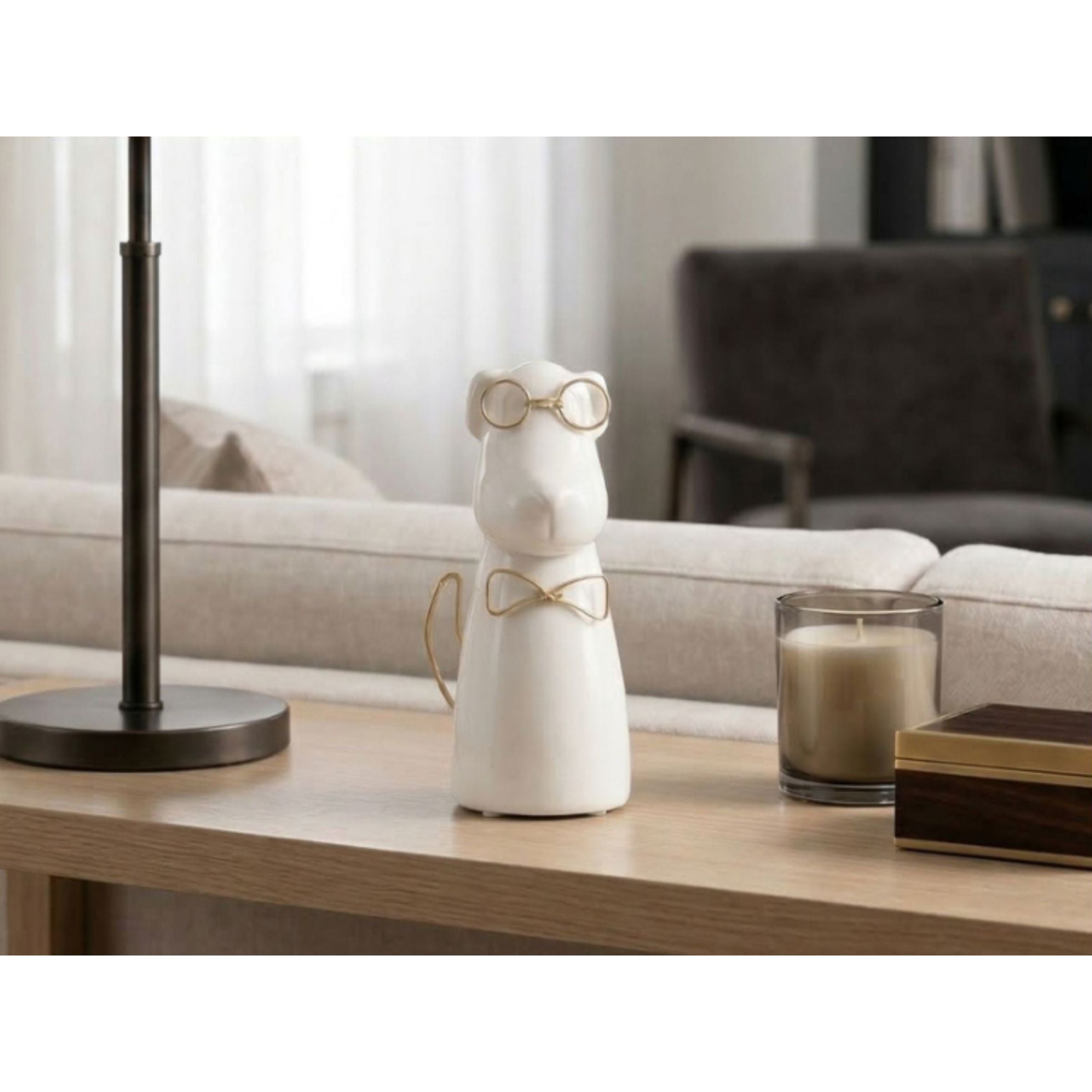 Ceramic hippo figurine with gold glasses and bow tie on a modern living room table.