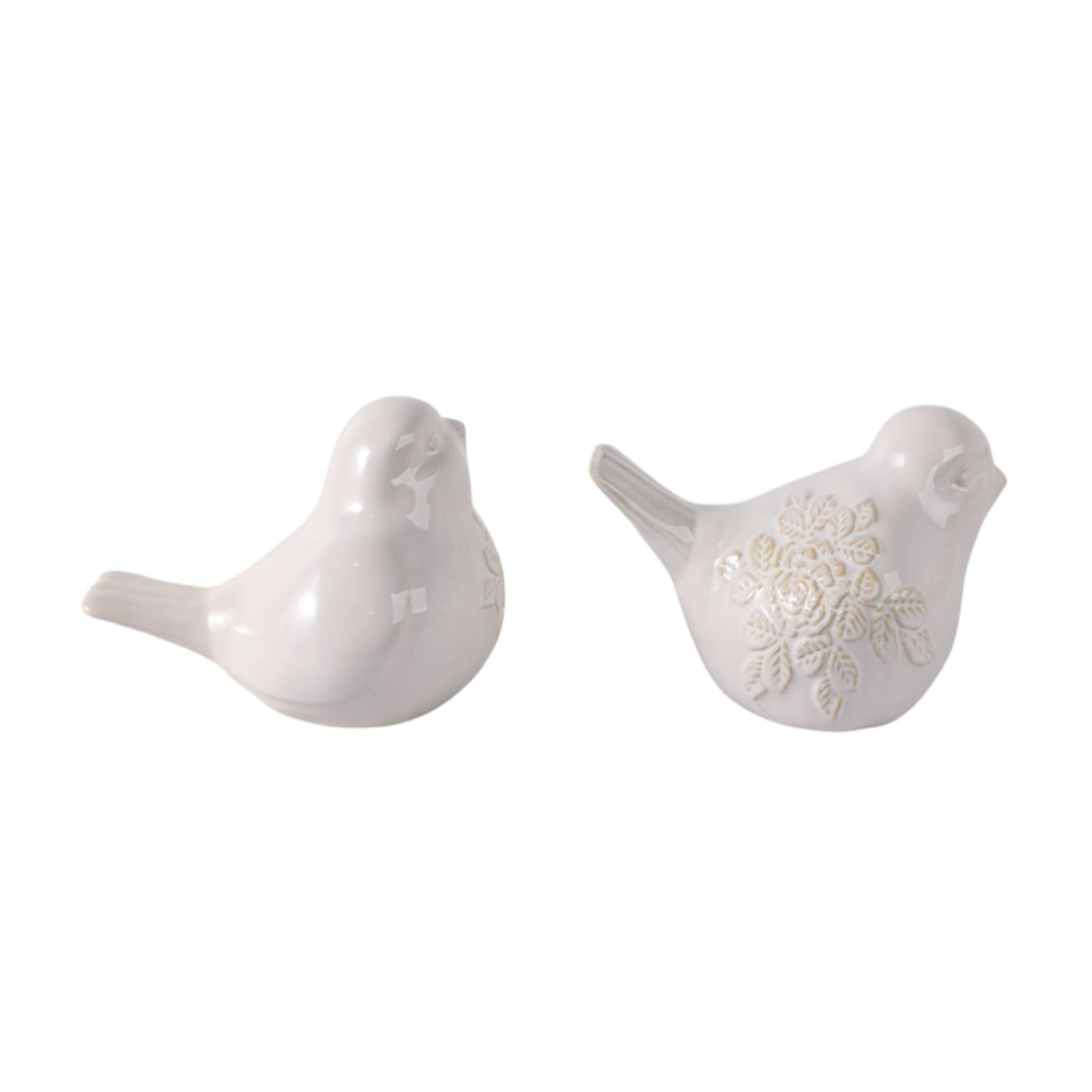 Two white ceramic bird figurines, one with a floral pattern.