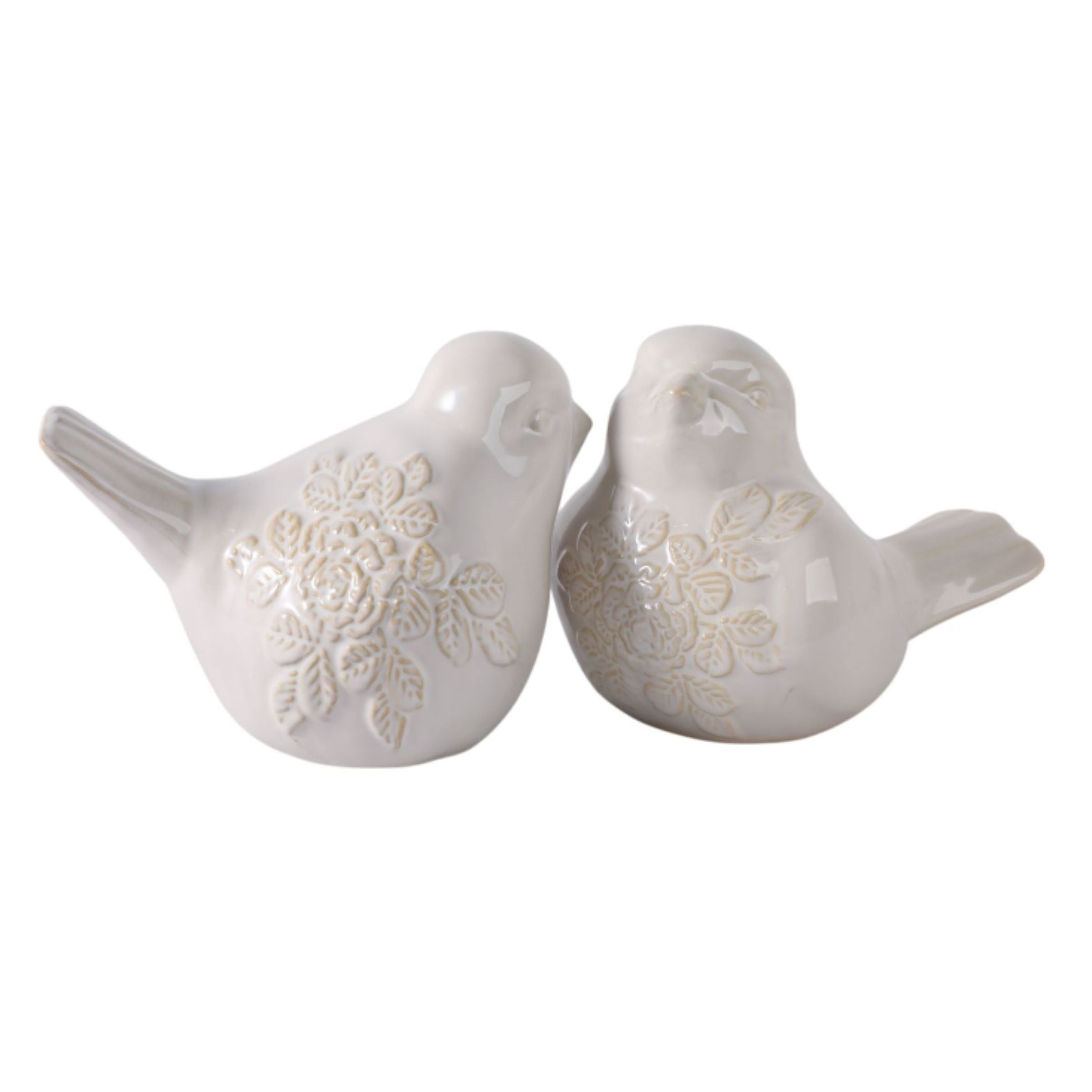 Pair of white ceramic birds with floral embossed design.