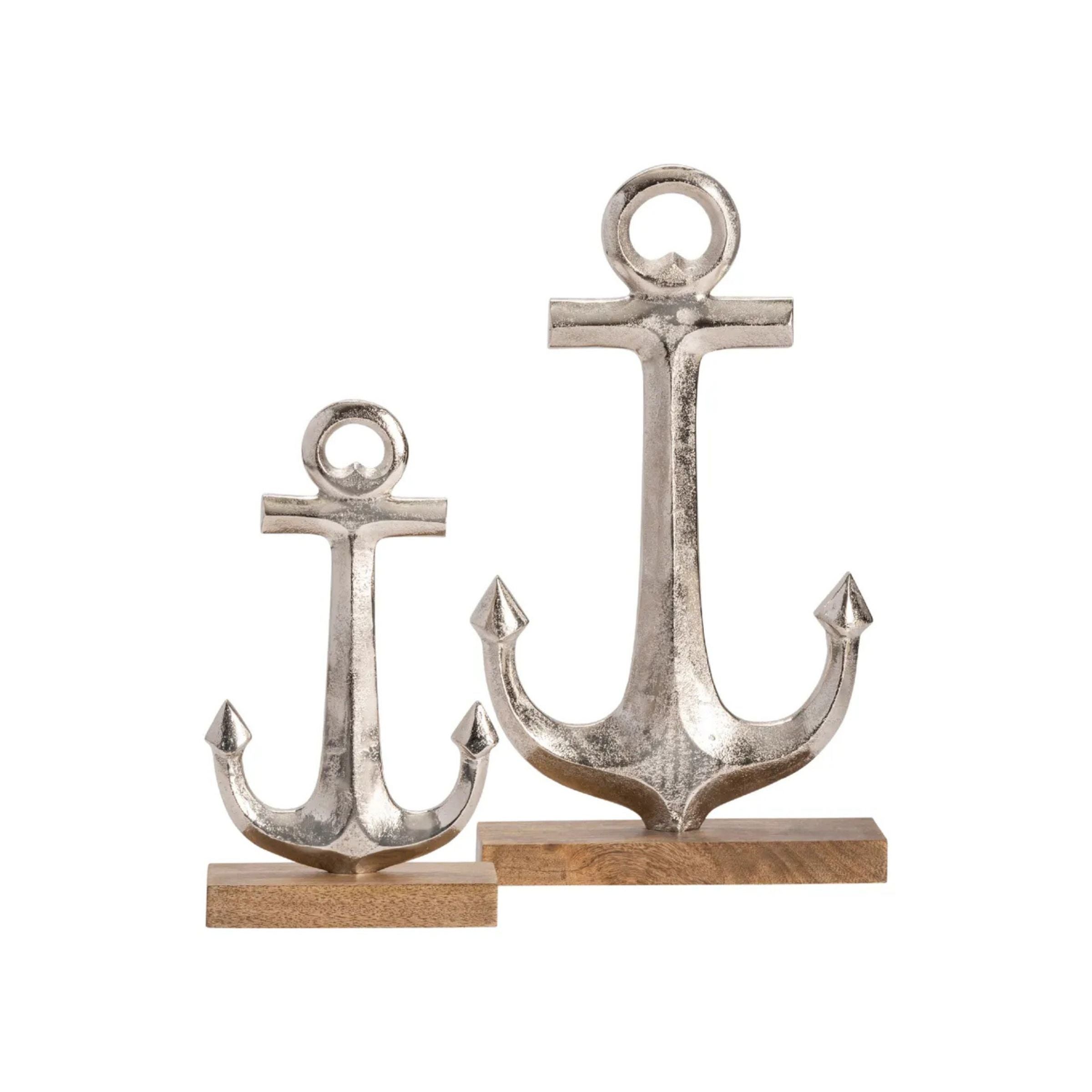 Two metallic anchor sculptures on wooden bases, one large and one small.