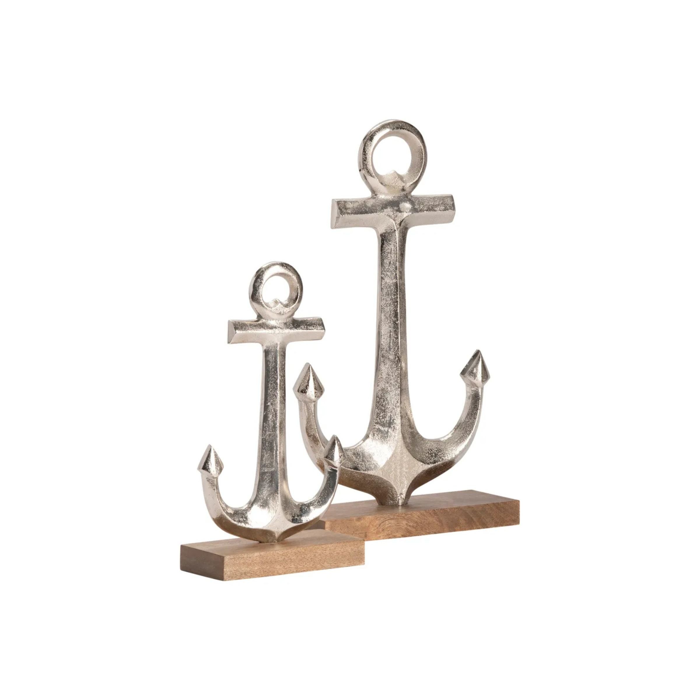 Two silver anchor sculptures on wooden bases, one large and one small.