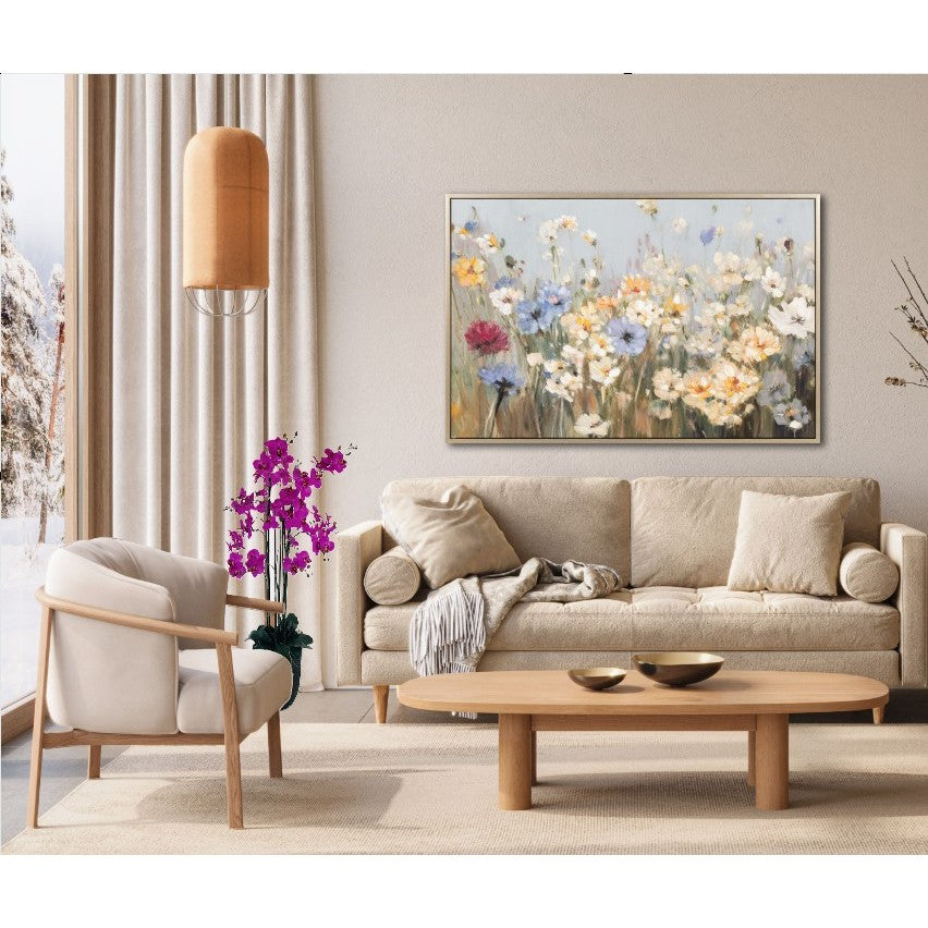 Neutral living room with beige sofa, wood furniture, and floral painting over the couch.
