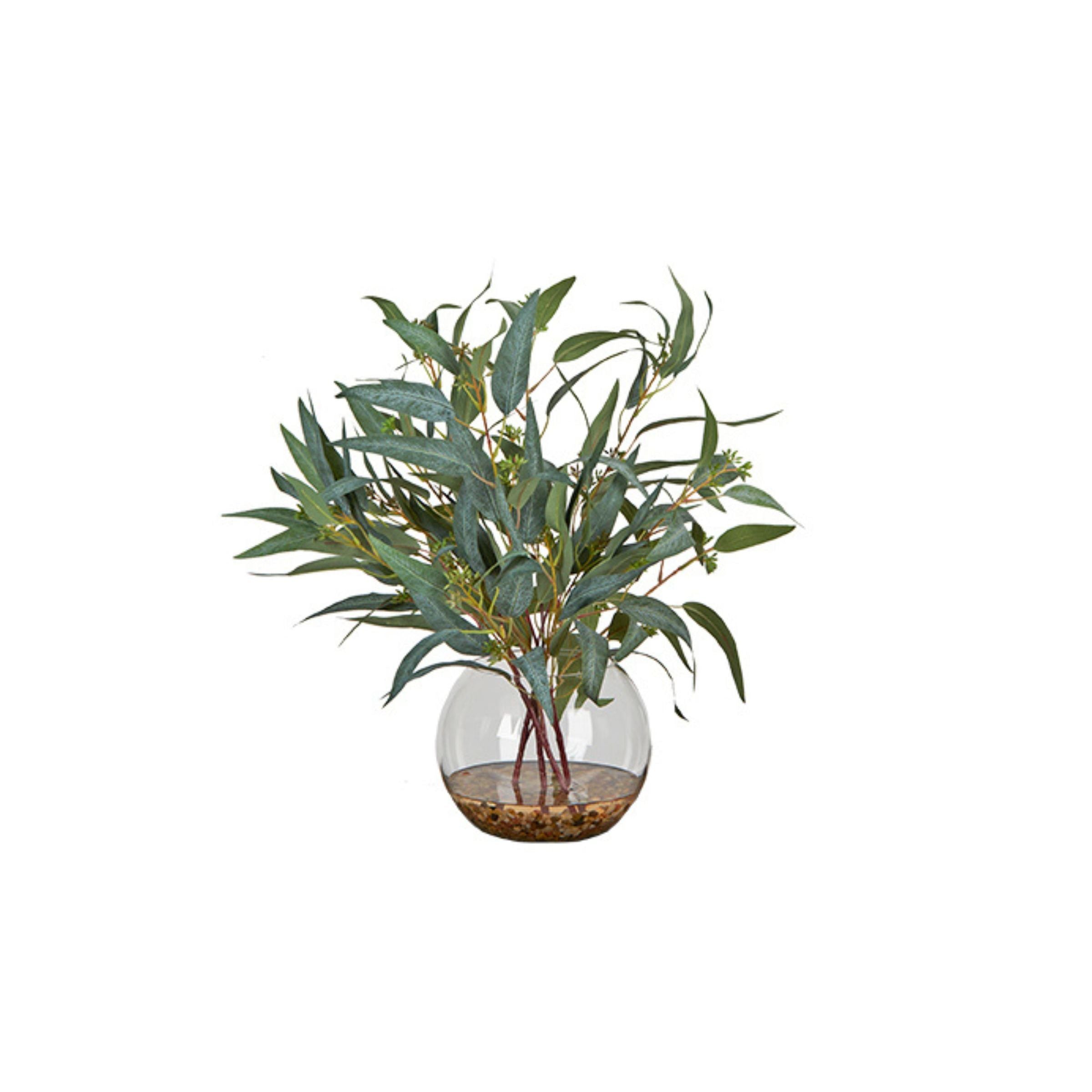 Artificial green plant in a round glass vase with pebbles, on a white background.
