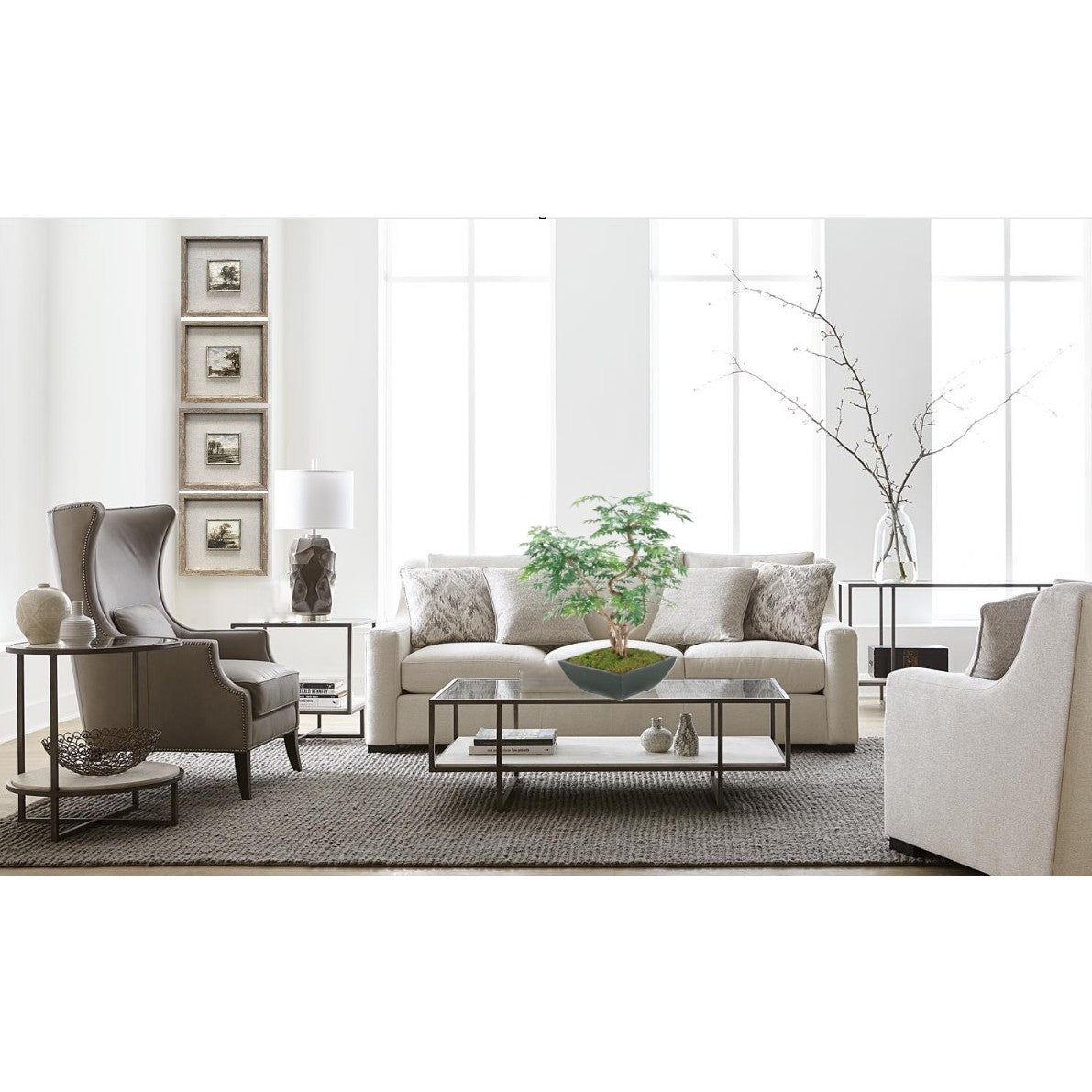 Modern living room with neutral sofas, glass table, and a bonsai plant as centerpiece.