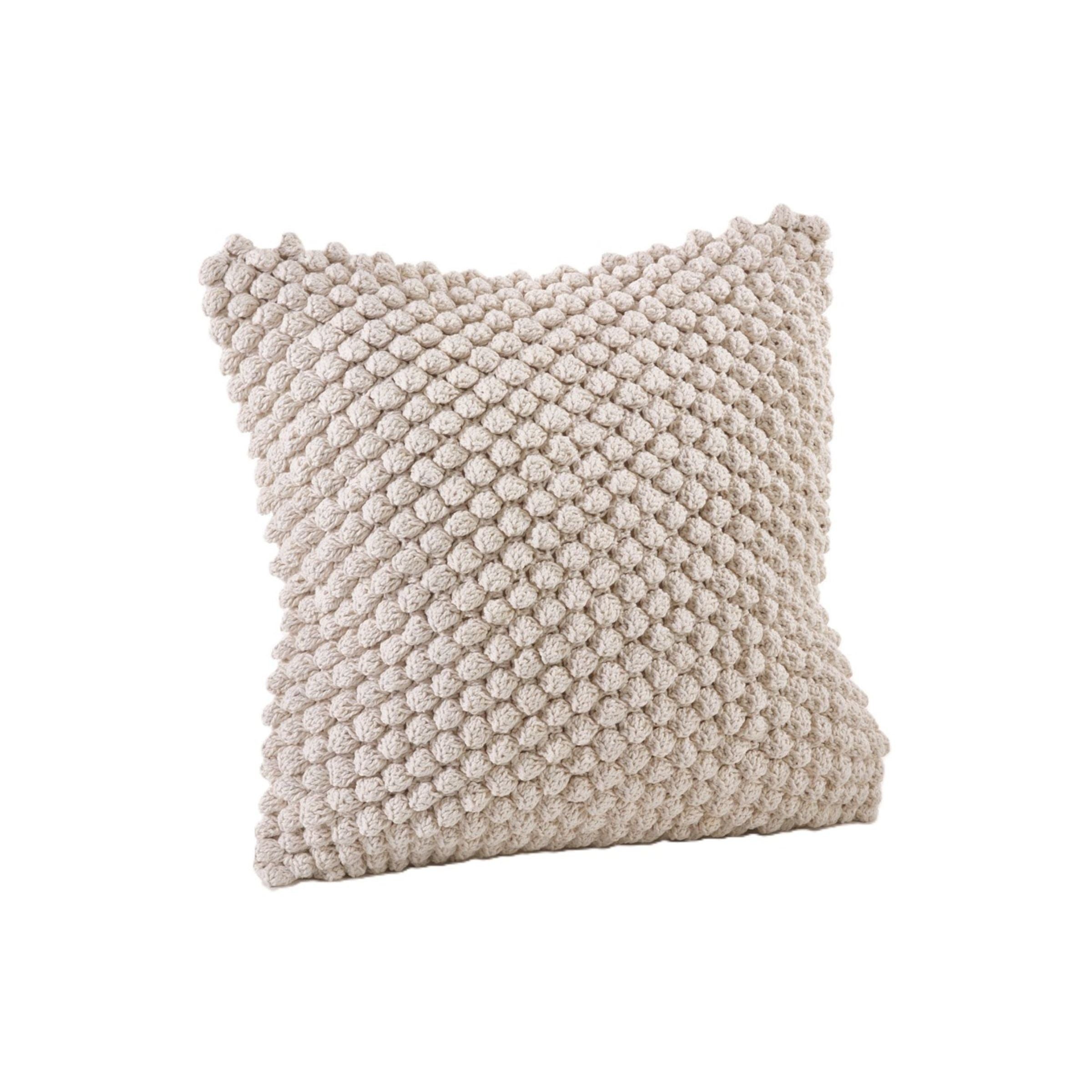 Beige textured throw pillow with a chunky knit design.