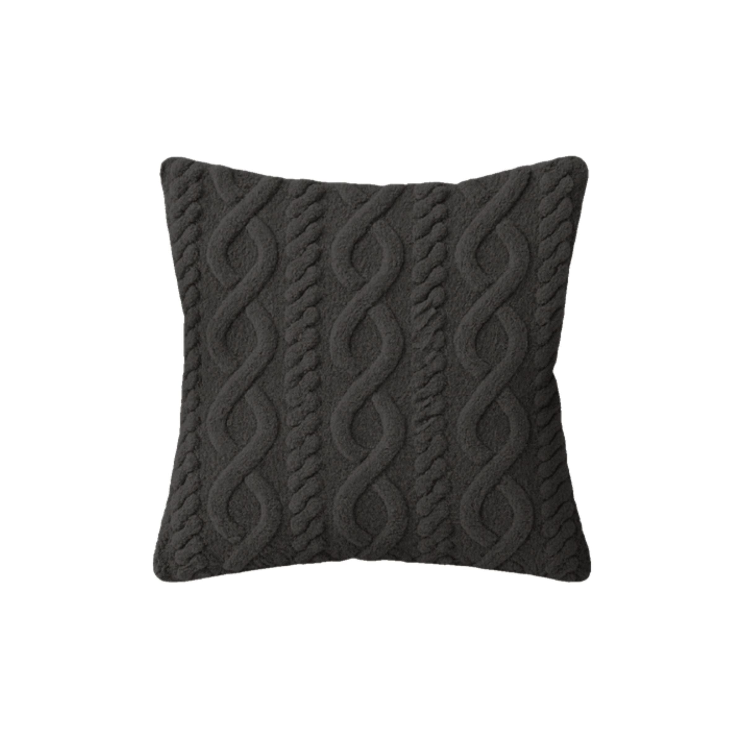 Dark gray pillow with a cable knit pattern.