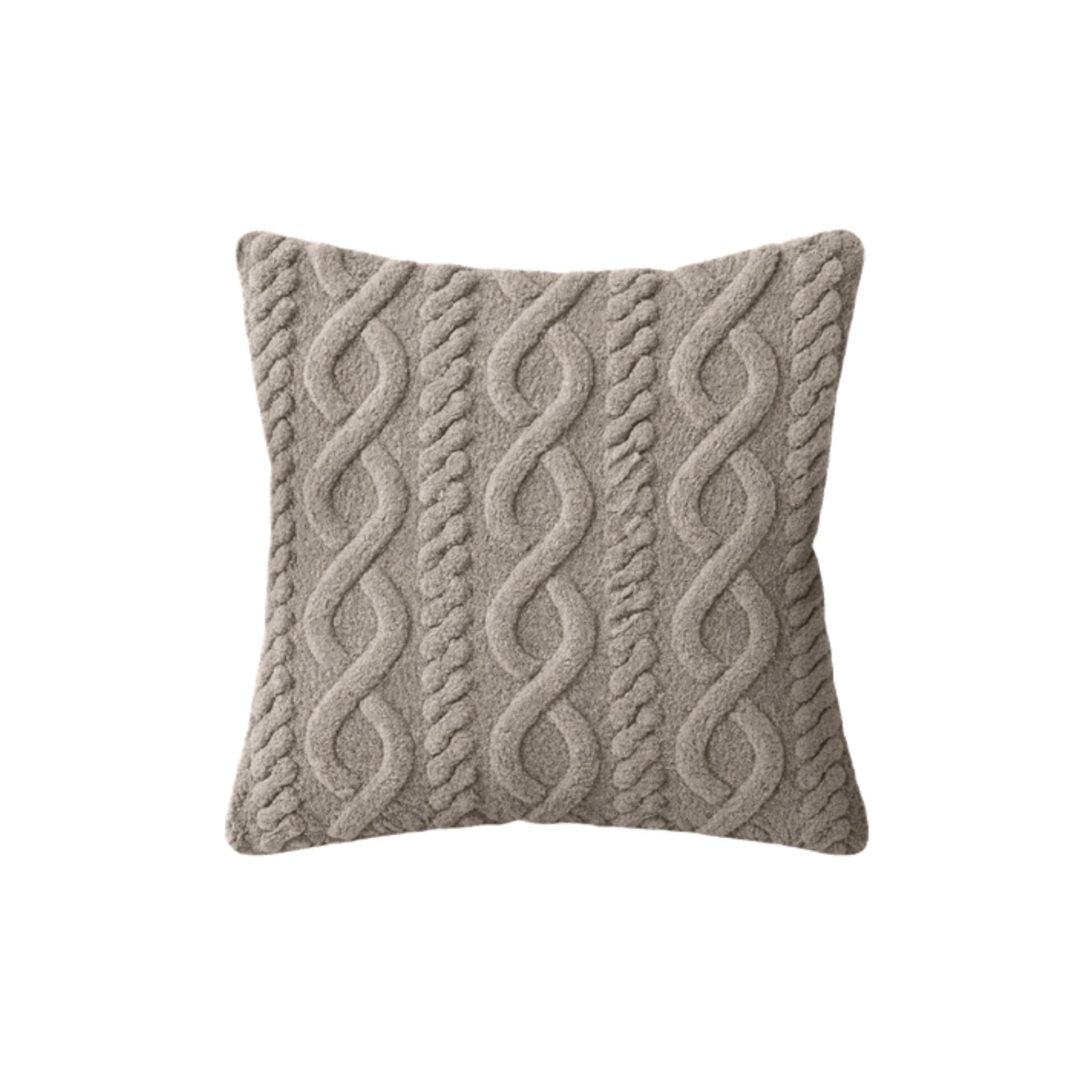 Beige pillow with raised cable knit pattern.