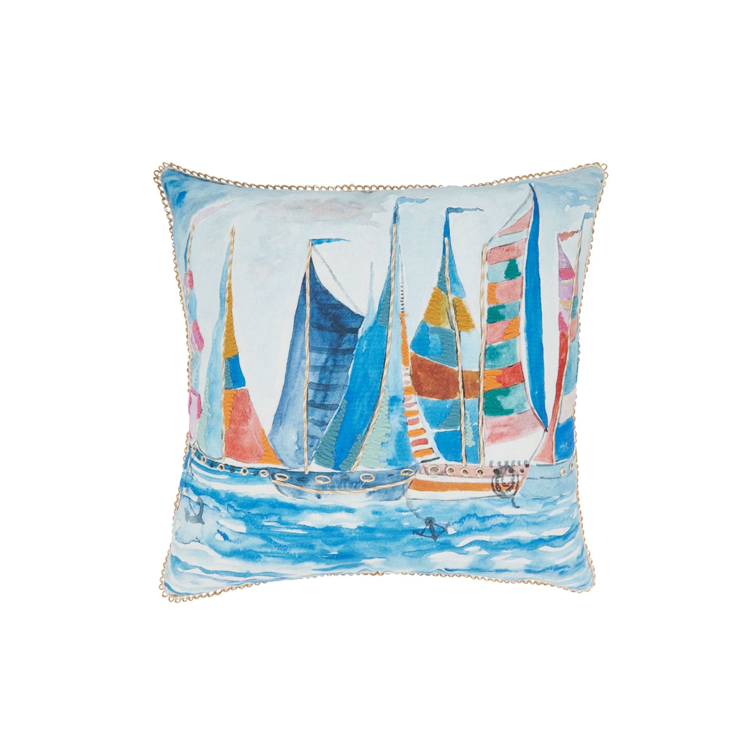 Decorative pillow with colorful sailboat illustration on water.