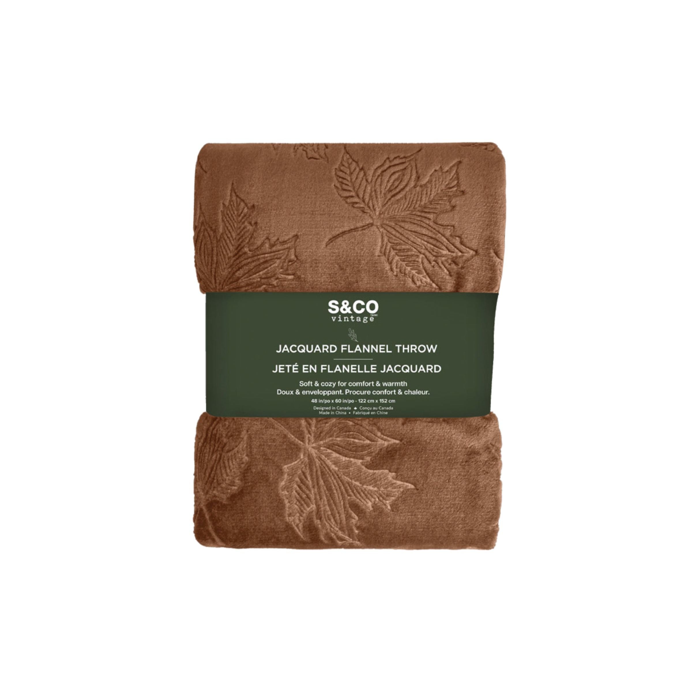 Folded brown jacquard flannel throw with embossed leaf pattern, S&CO Vintage label visible.