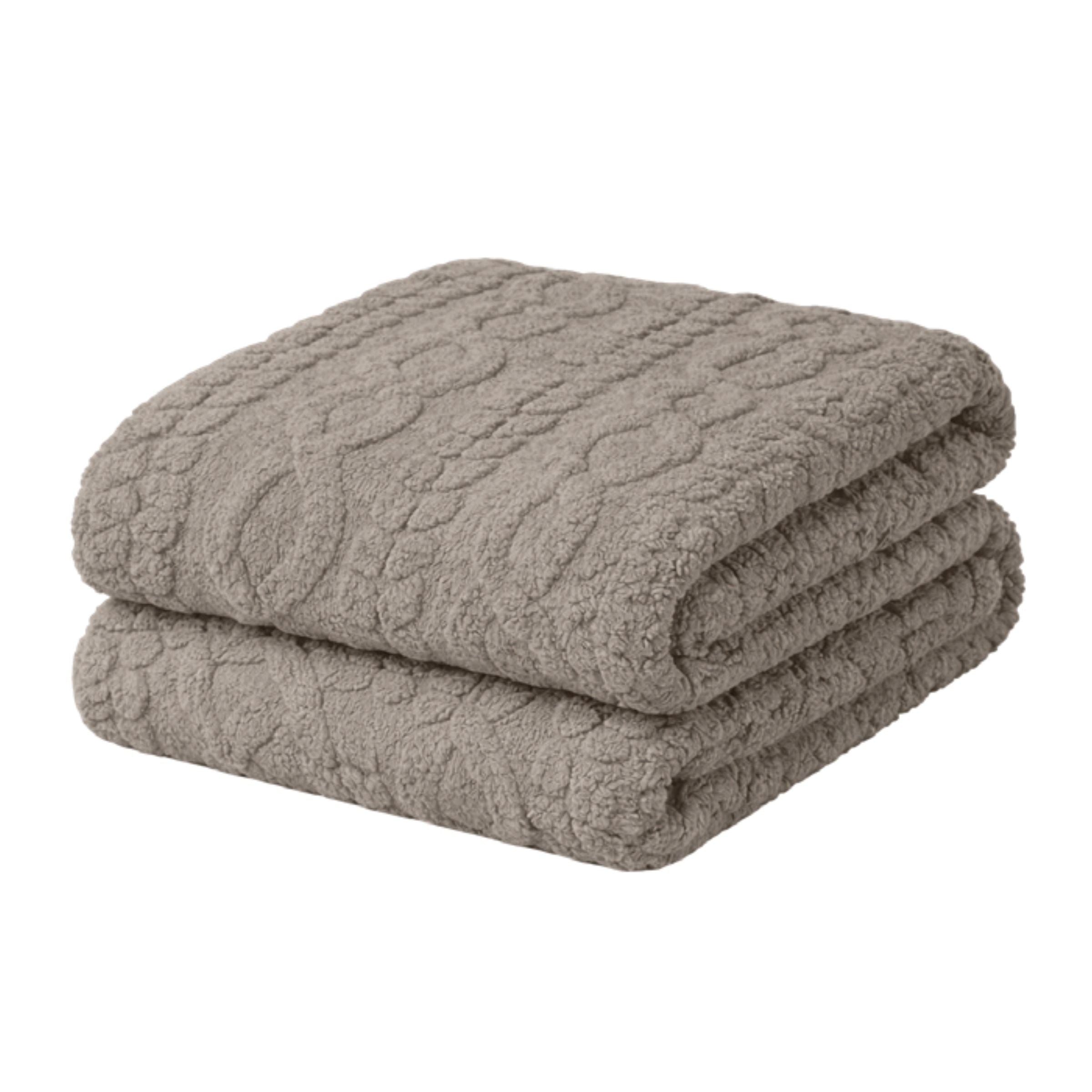 Folded gray textured blanket with a cable knit pattern.