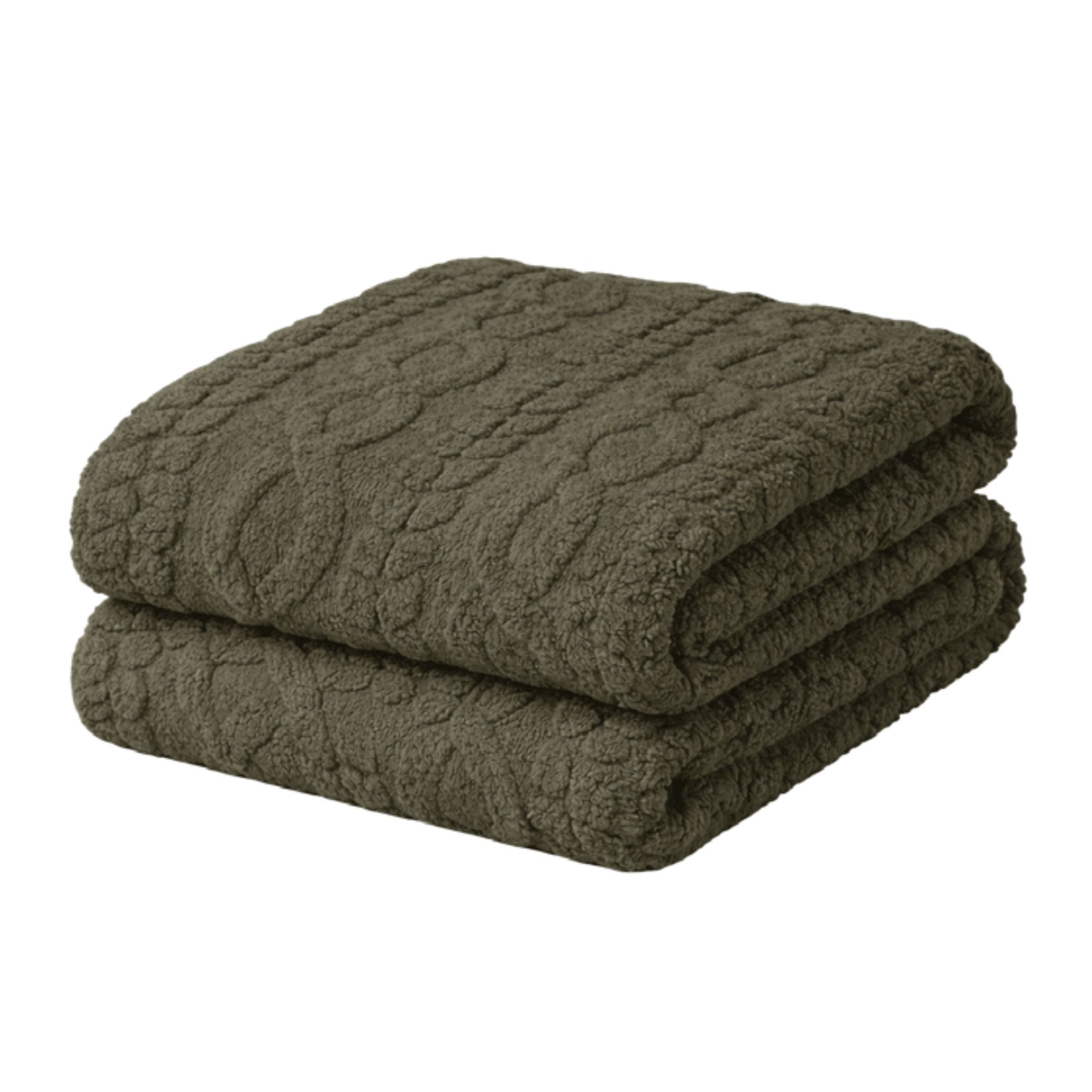 Folded, dark green textured blanket on a white background.