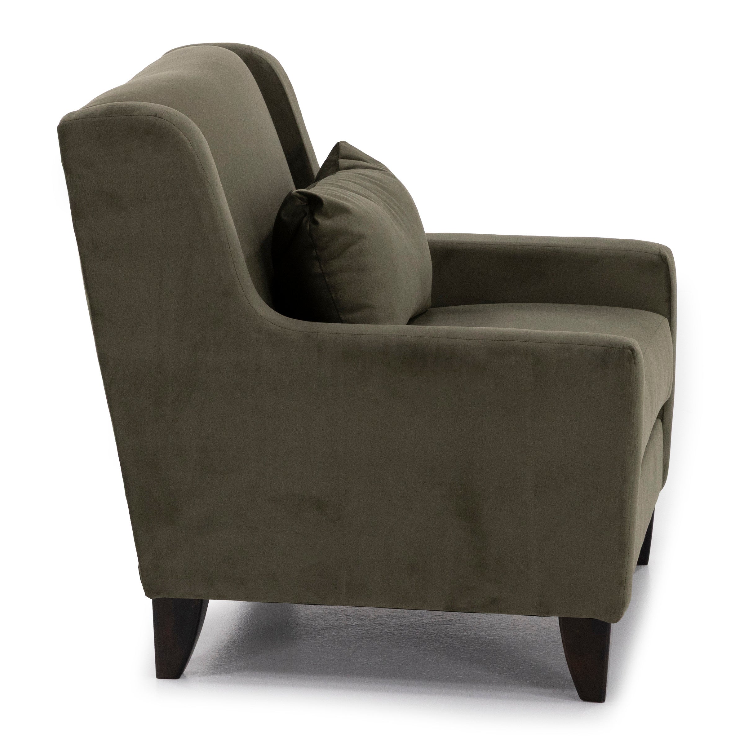 Side view of a modern olive green armchair with a matching pillow on wooden legs.