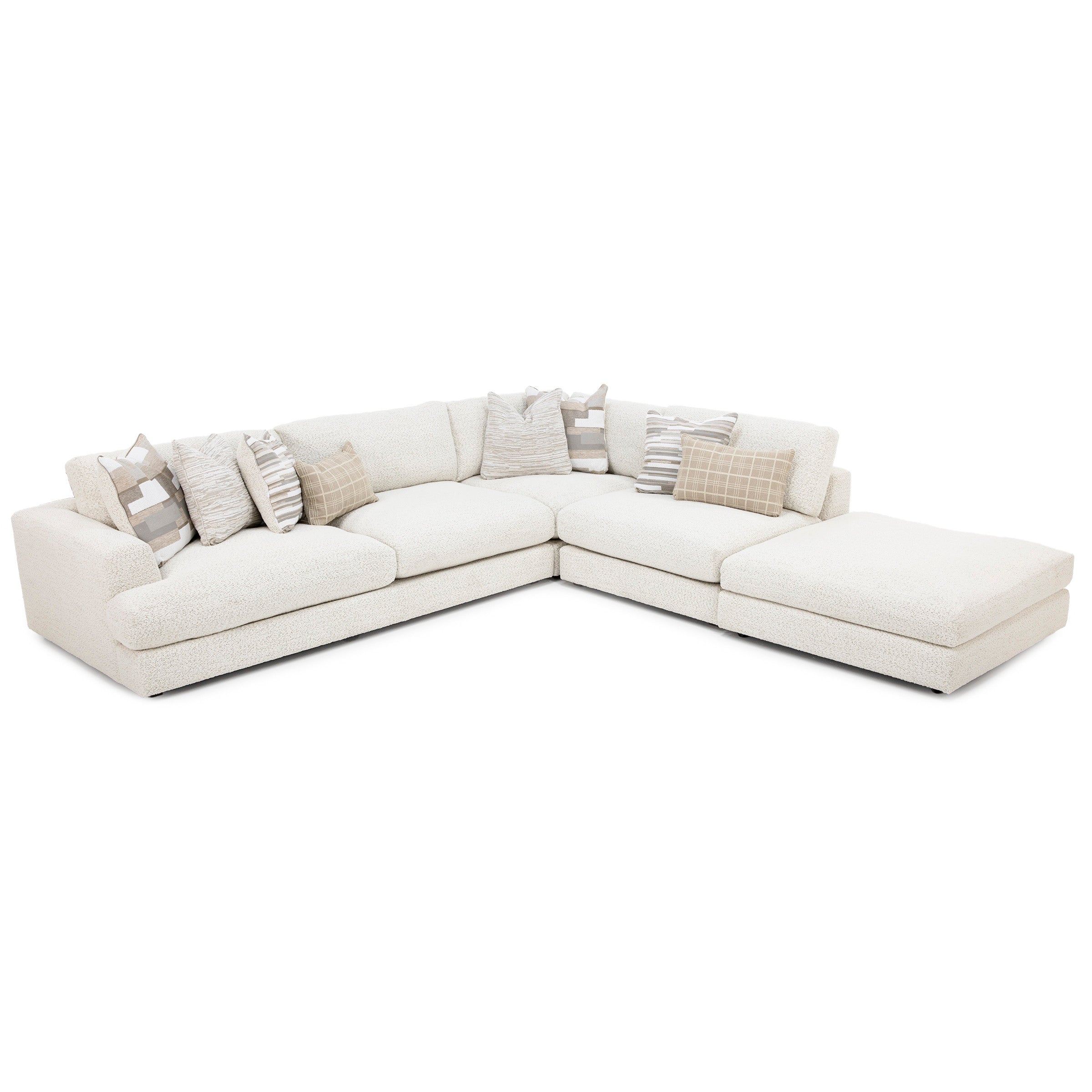 Modern white sectional sofa with assorted neutral pillows.