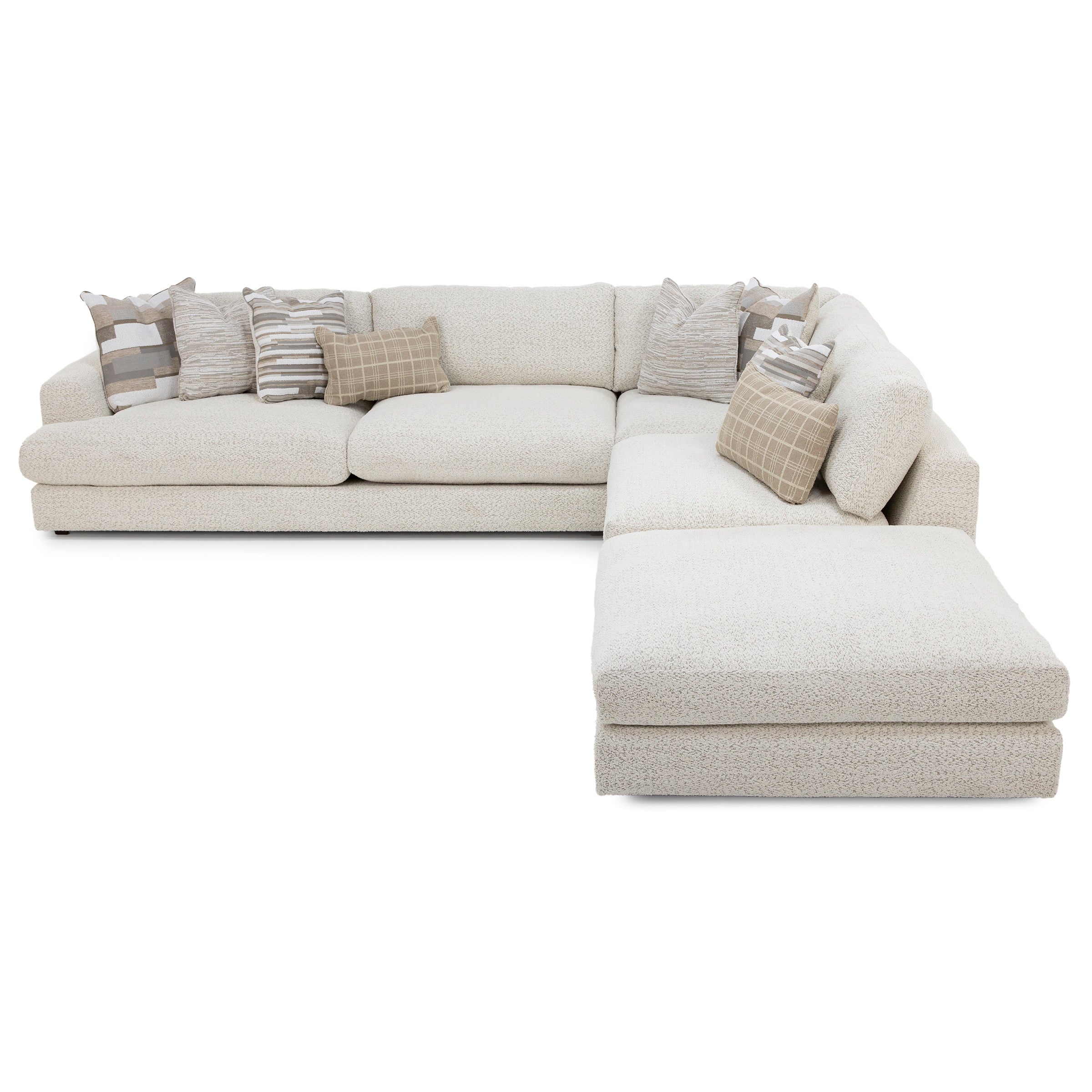 Beige L-shaped sectional sofa with assorted neutral throw pillows.
