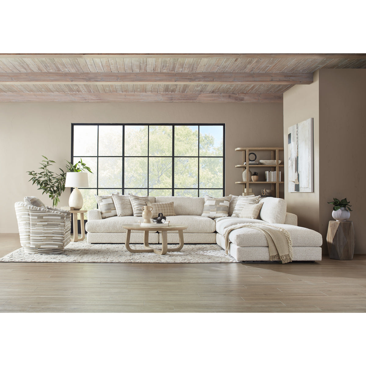 Modern living room with large sectional sofa, accent chair, and neutral decor.