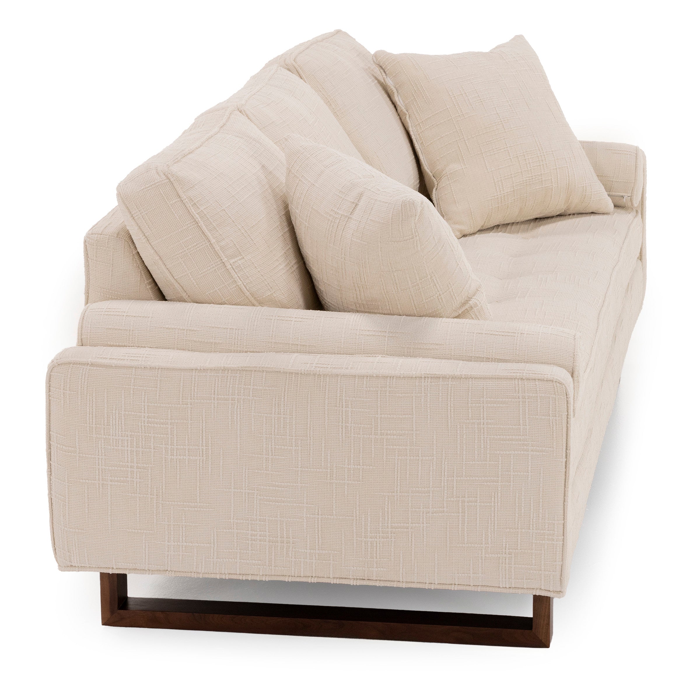 Beige modern sofa with textured fabric and wooden base, viewed from the side.
