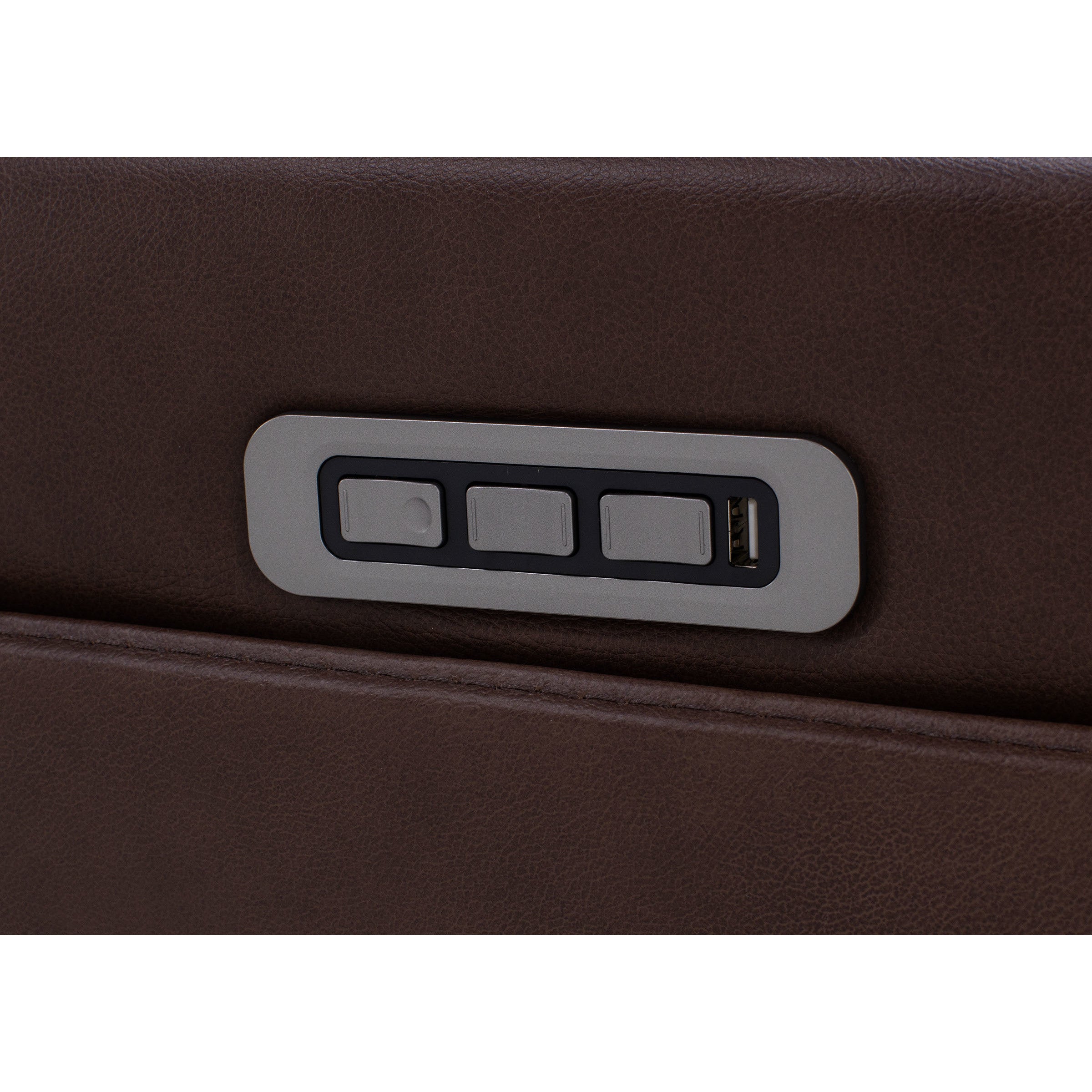 Close-up of three control buttons and a USB port on brown leather furniture.