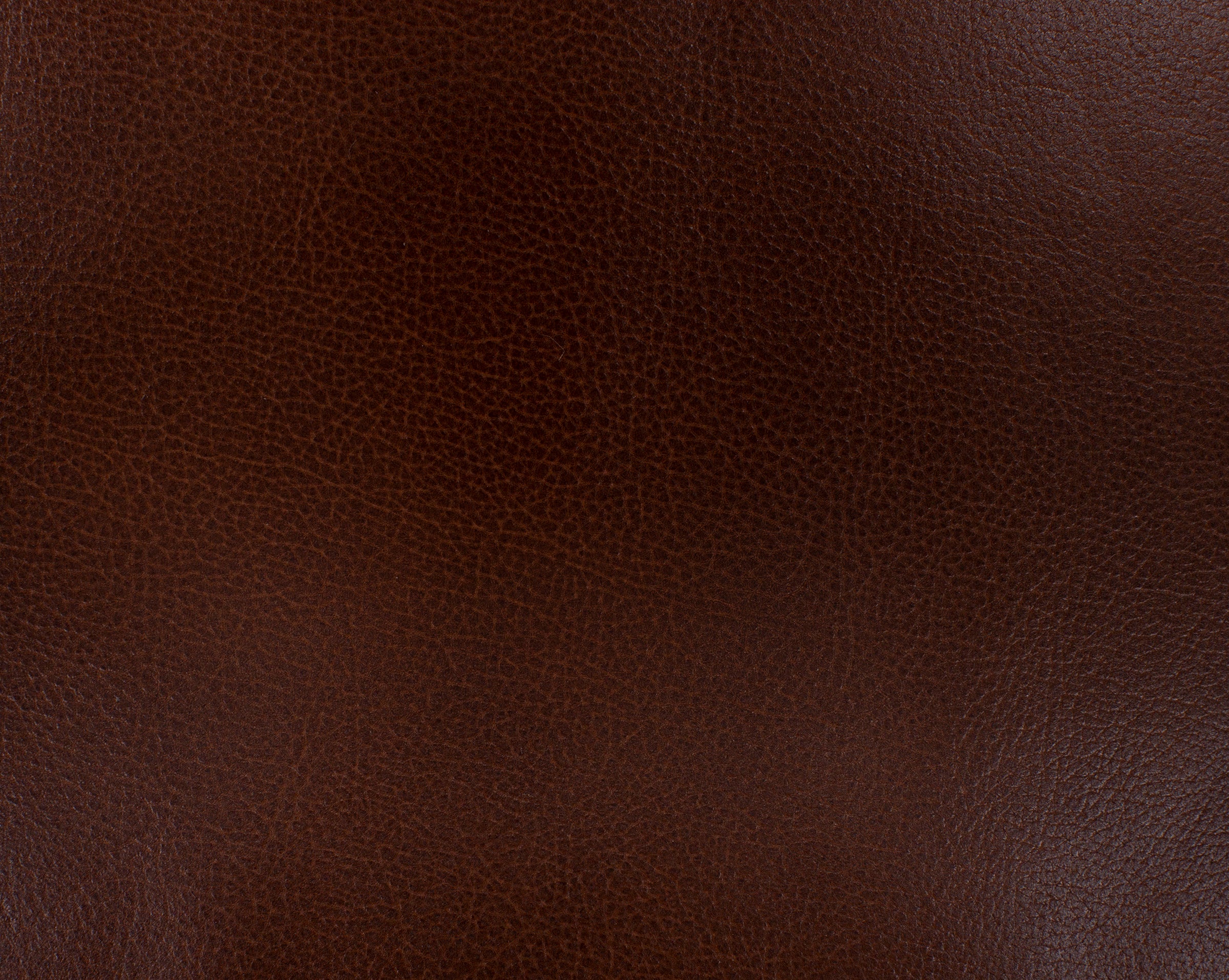 Dark brown leather texture, close-up.