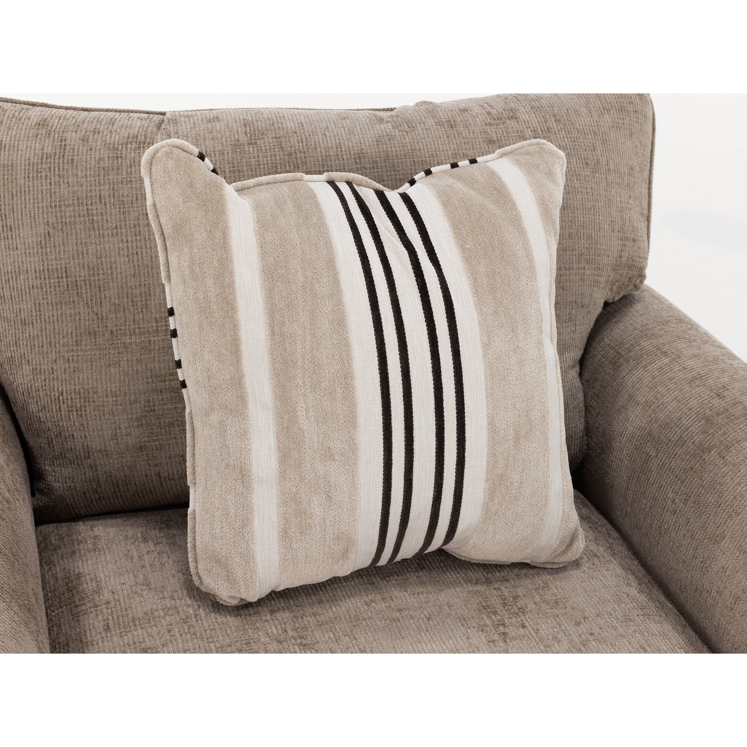 Tan and white striped pillow on a textured beige armchair.