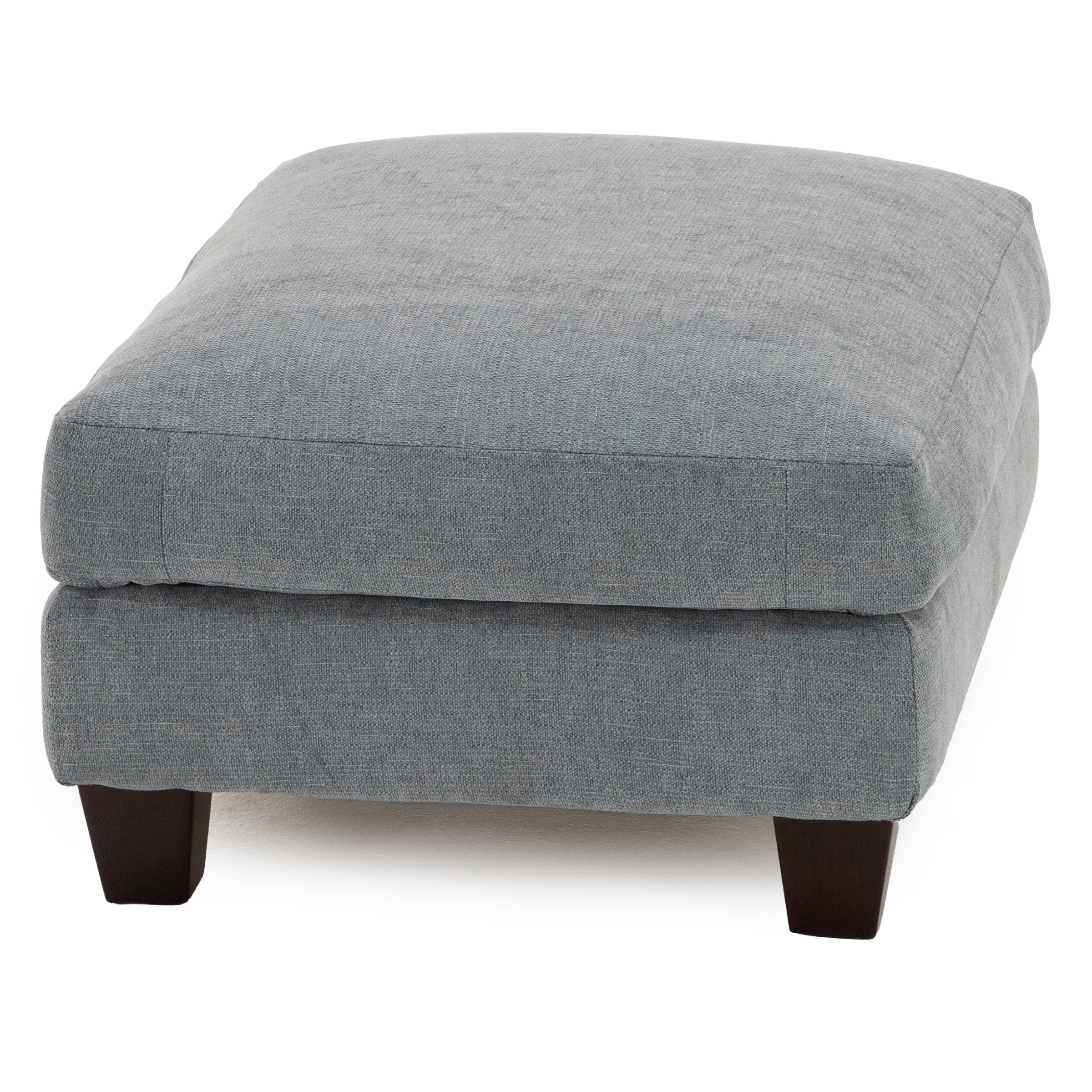 Gray upholstered ottoman with dark wooden legs.