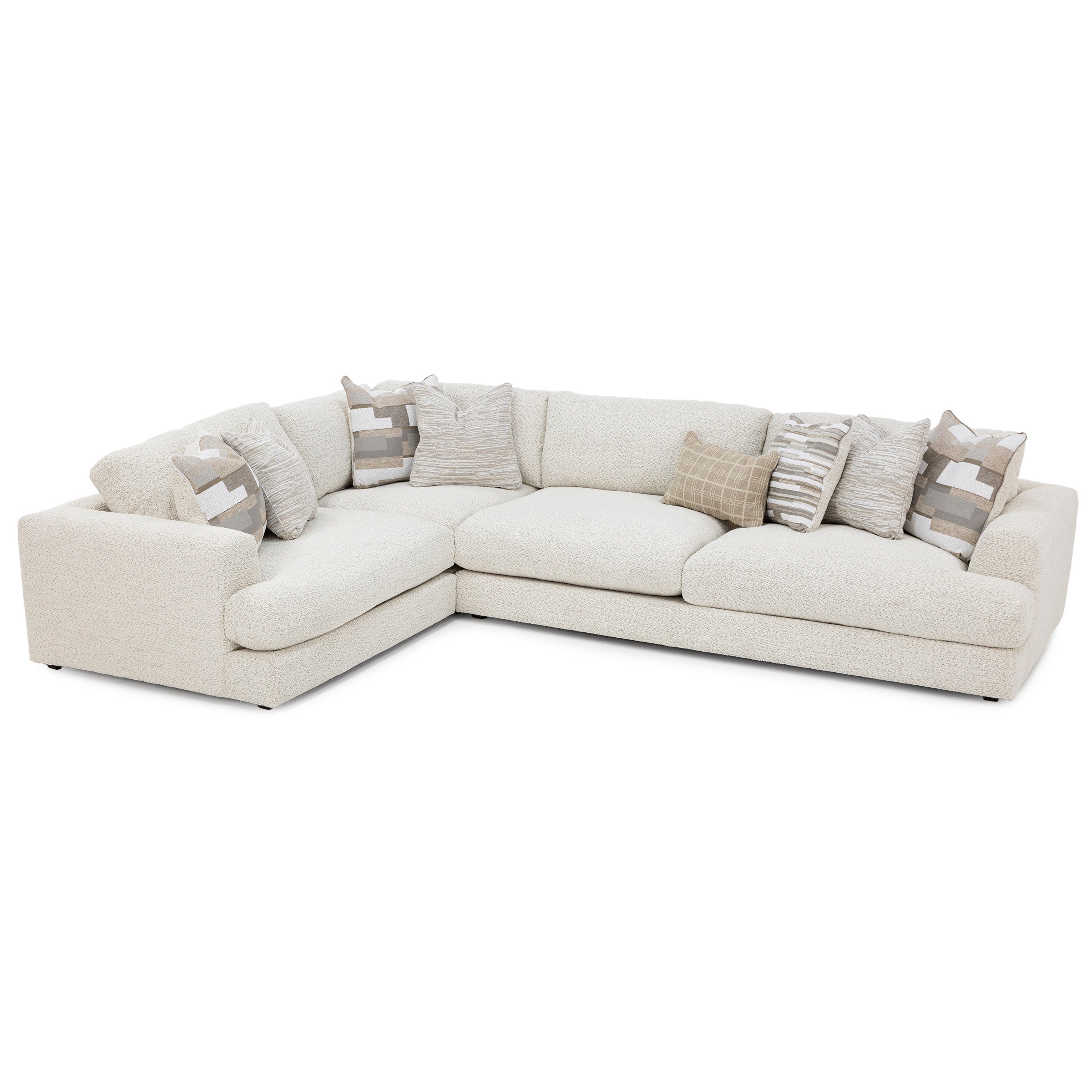 Cream-colored sectional sofa with assorted neutral pillows.