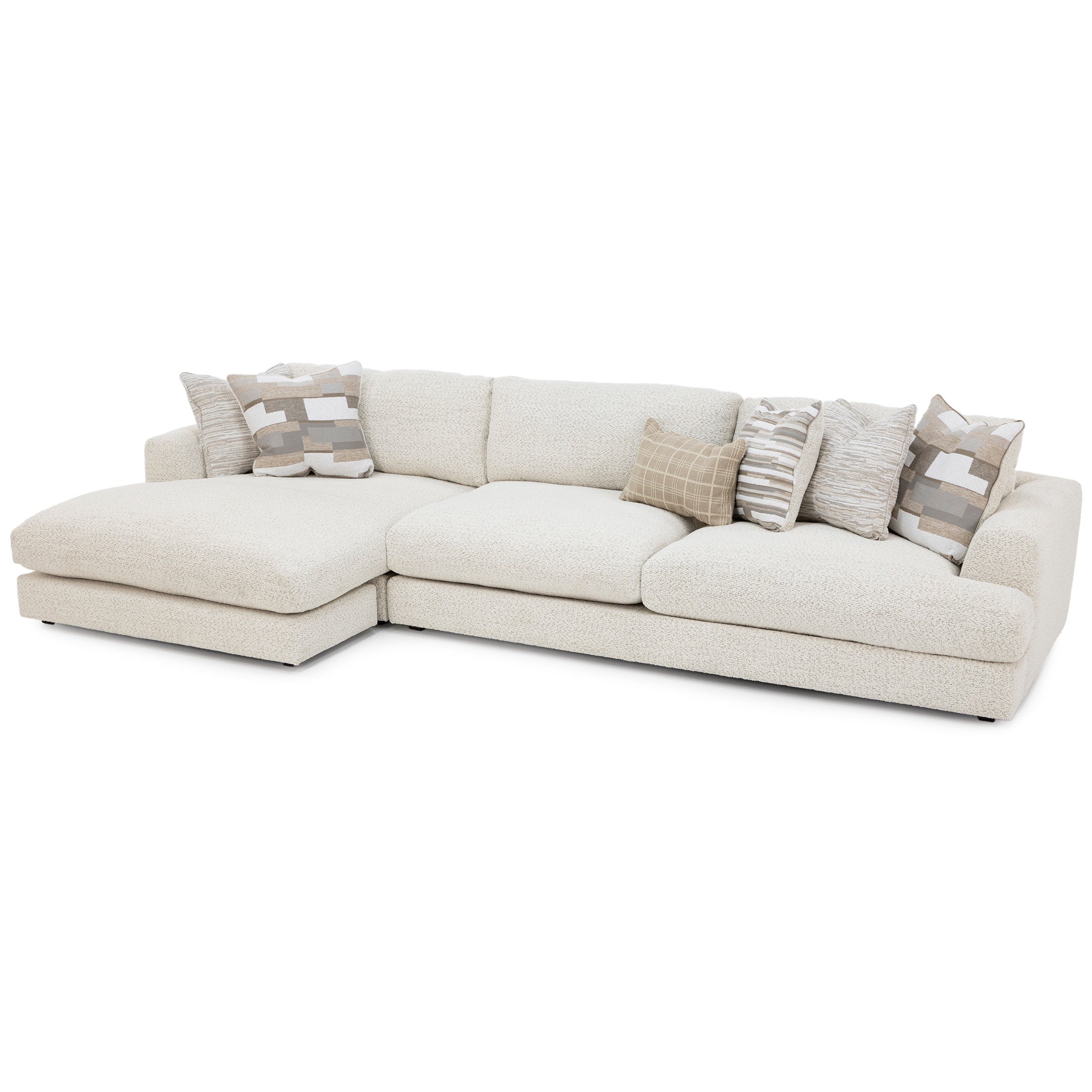 Cream sectional sofa with patterned throw pillows.