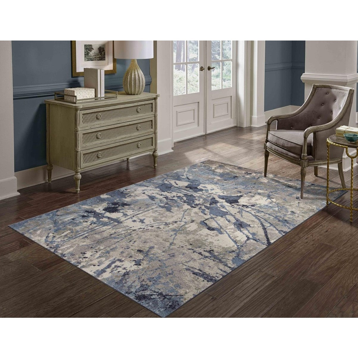 Blue and gray abstract area rug in a modern living room setting.