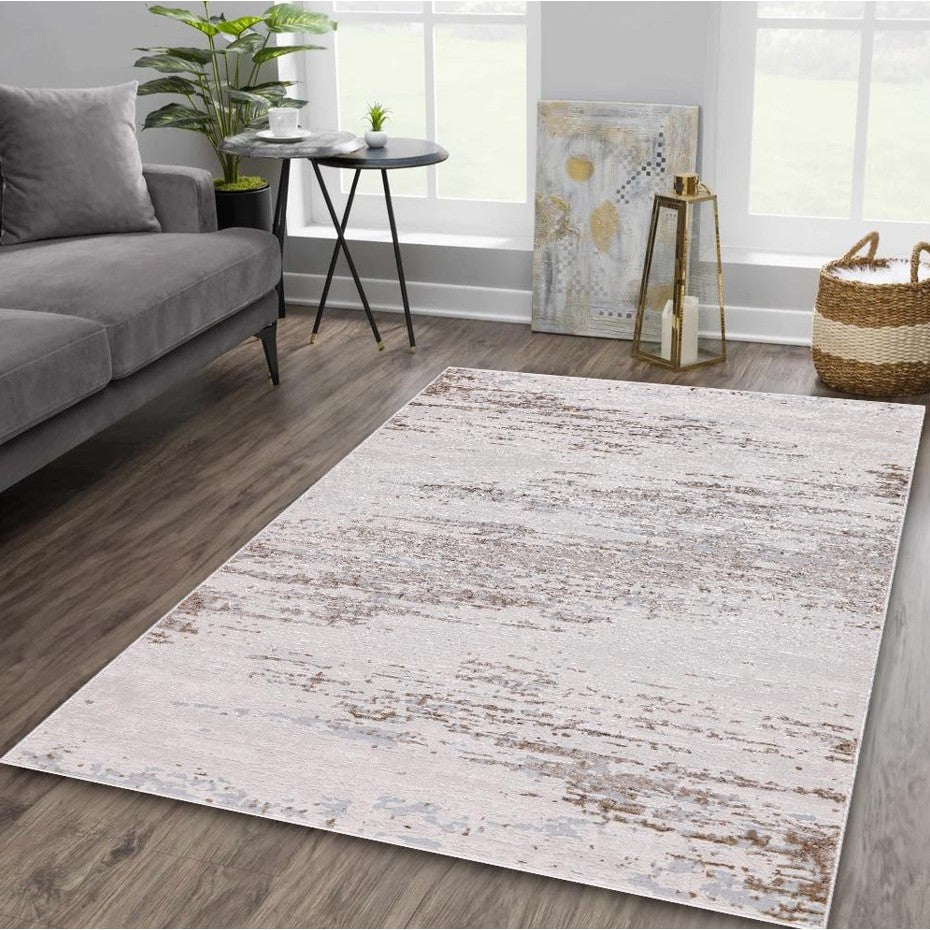 Neutral modern area rug in a living room with a gray sofa and wood floors