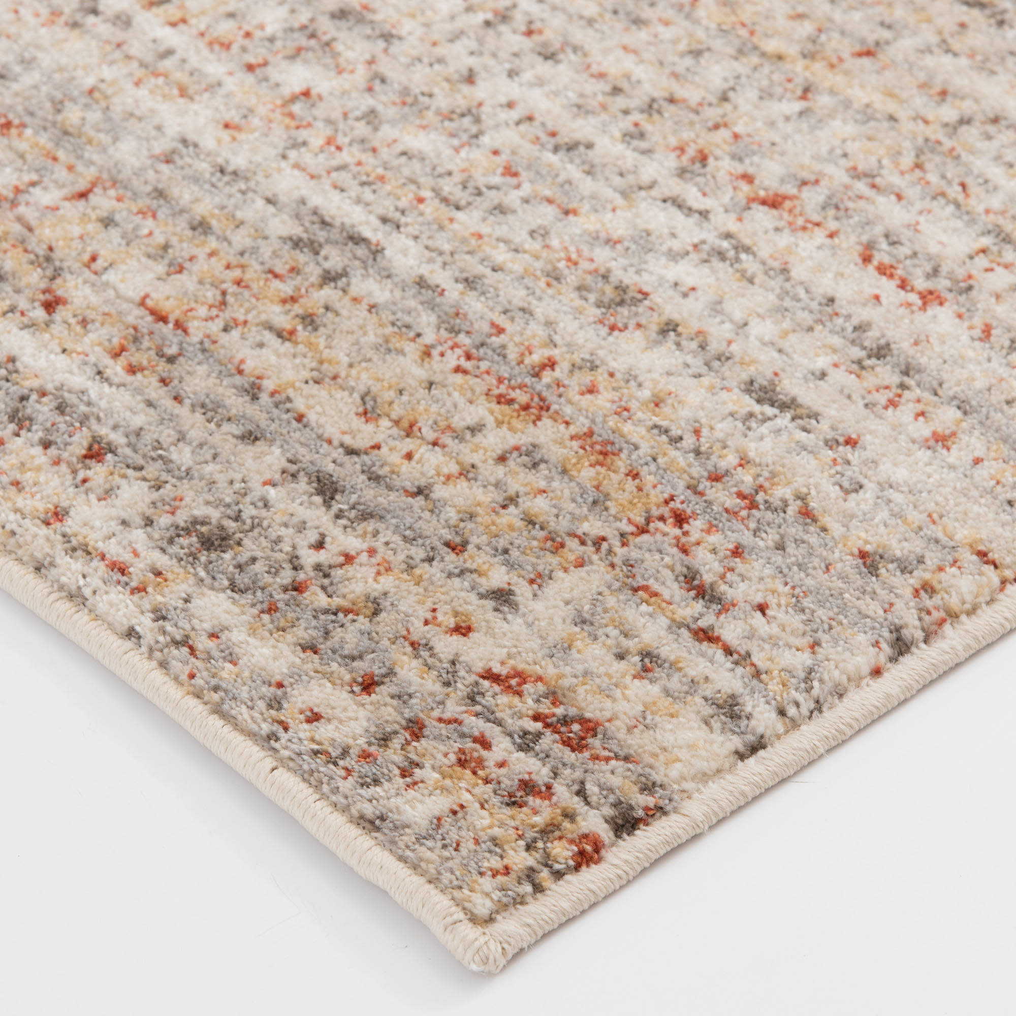 Corner of a multicolor textured area rug with beige, gray, and rust tones.