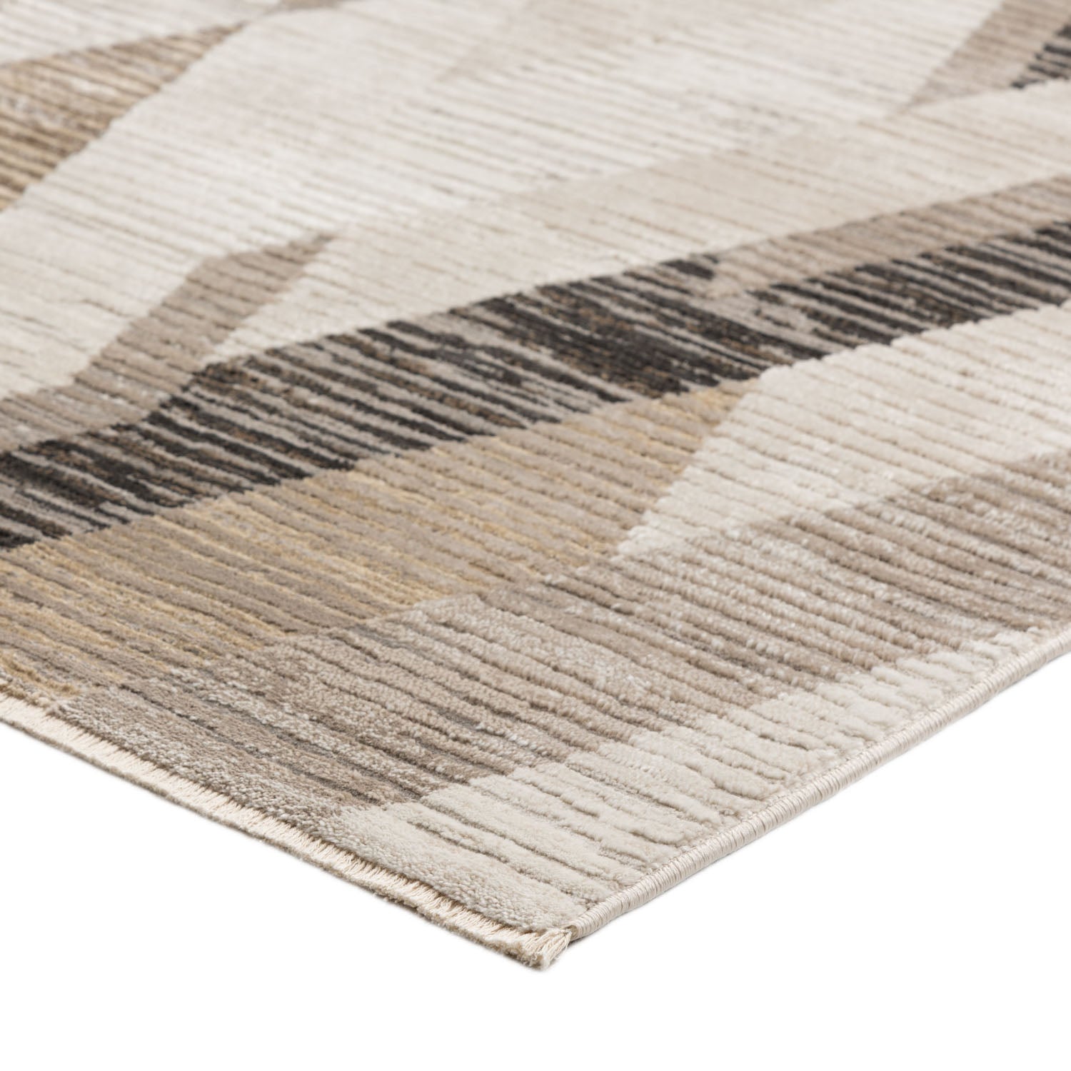 Close-up of a modern area rug with a geometric pattern in neutral tones.